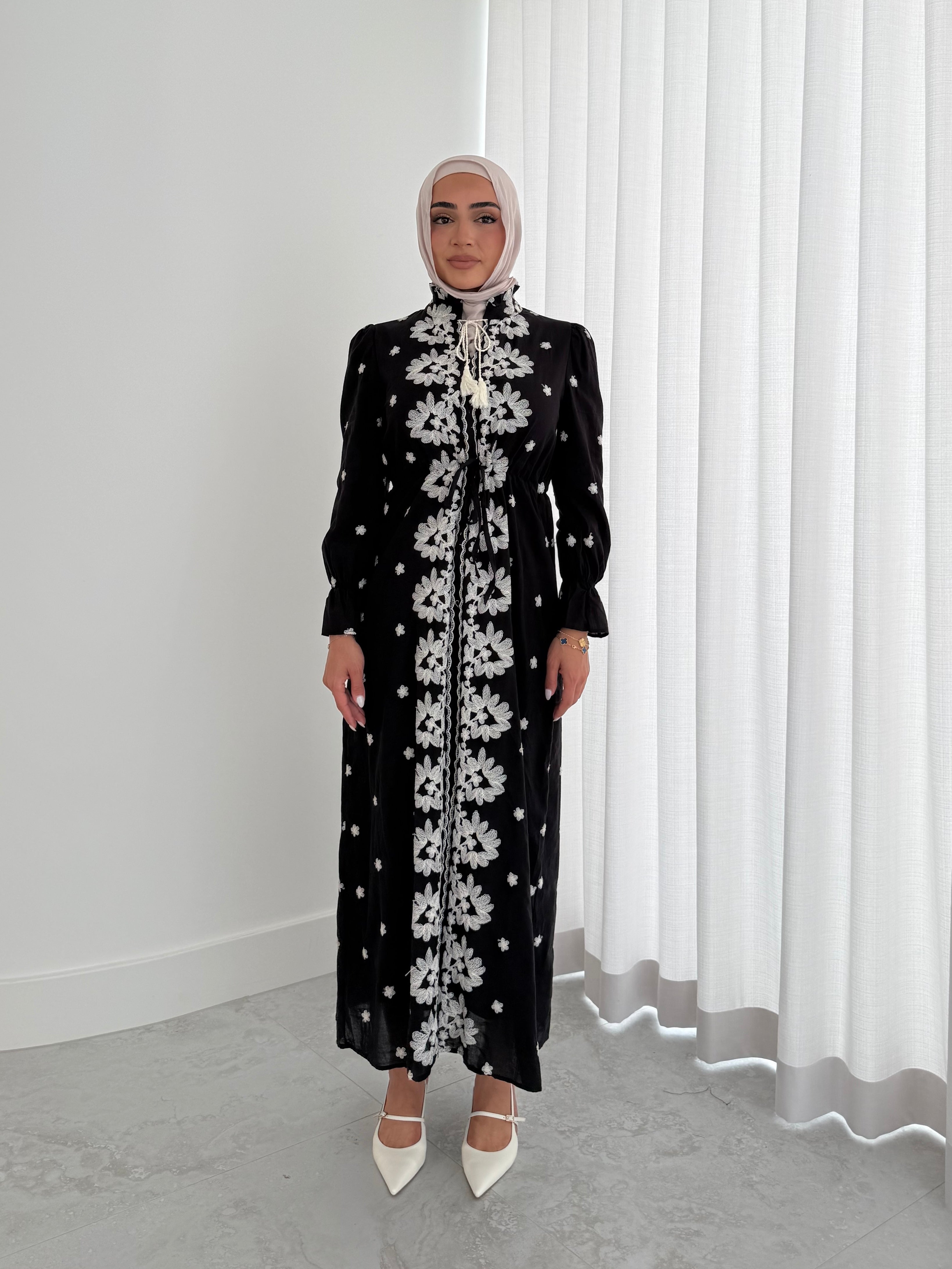 women's modest maxi dress in black and ivory with floral embroidery. dress is lined, long sleeve and lightweight, hijabi friendly and feminine for brunch, party, dinner, events and eid.