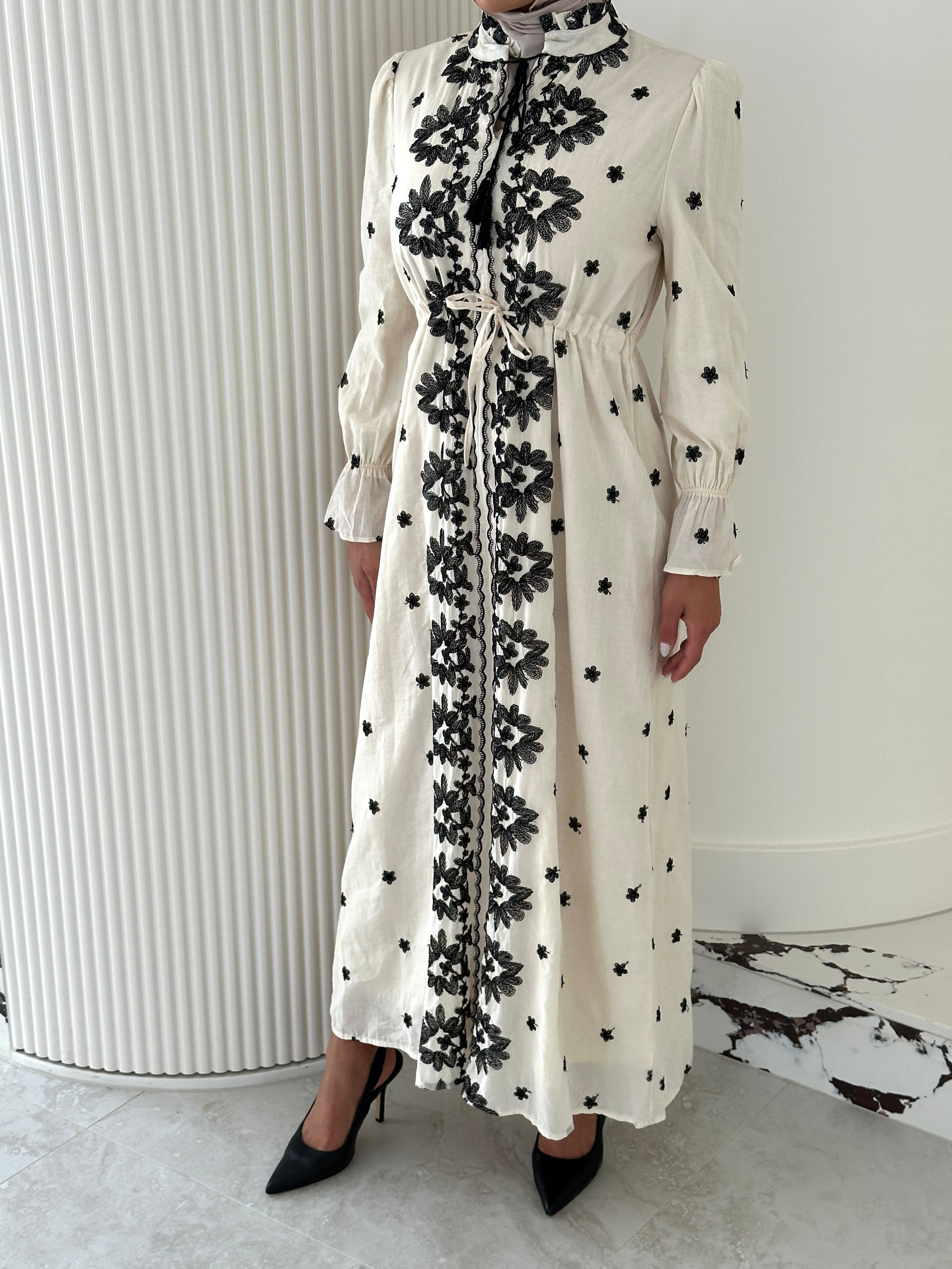 women's modest maxi dress in black and ivory with floral embroidery. dress is lined, long sleeve and lightweight, hijabi friendly and feminine for brunch, party, dinner, events and eid.