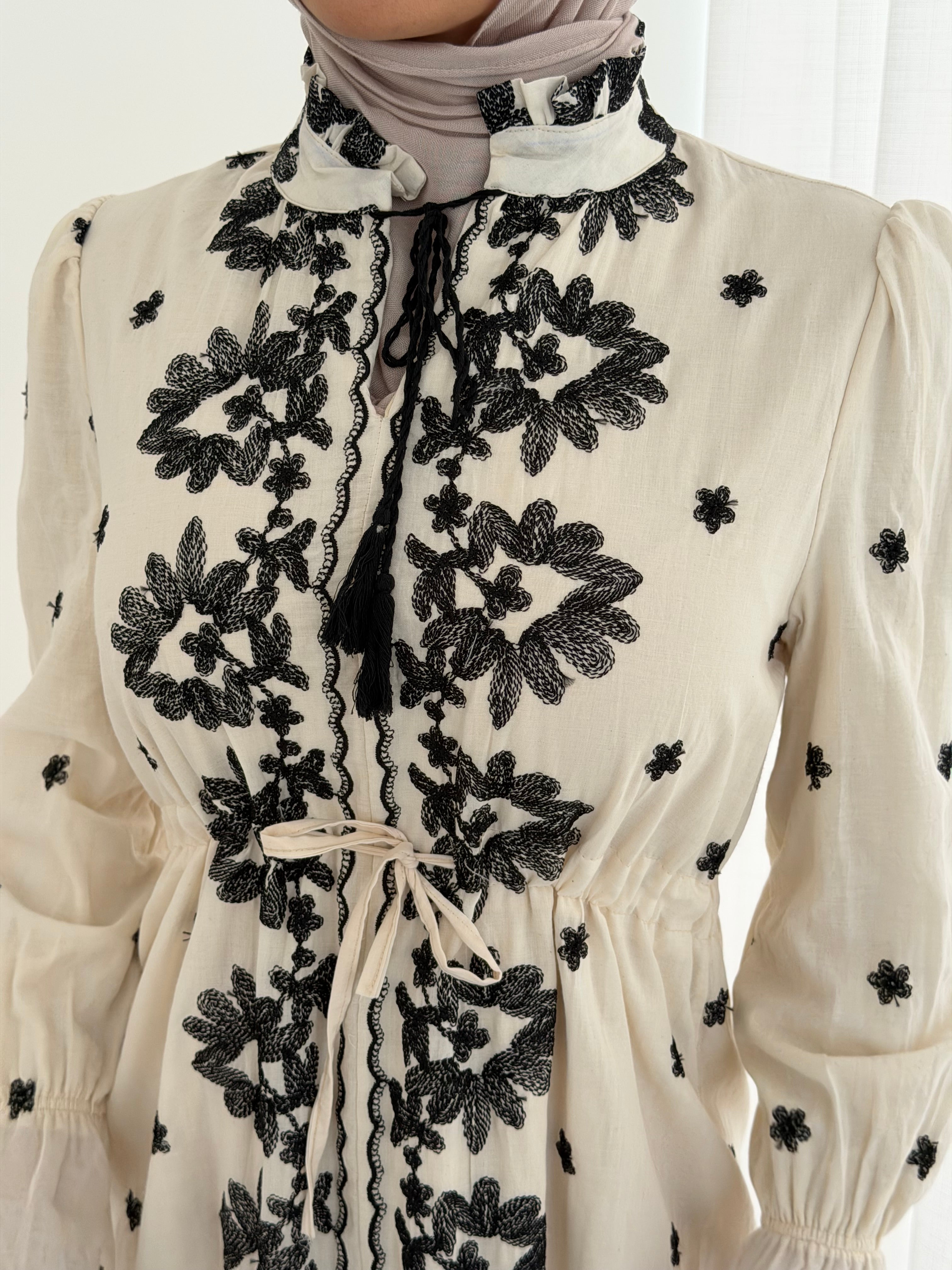 women's modest maxi dress in black and ivory with floral embroidery. dress is lined, long sleeve and lightweight, hijabi friendly and feminine for brunch, party, dinner, events and eid.