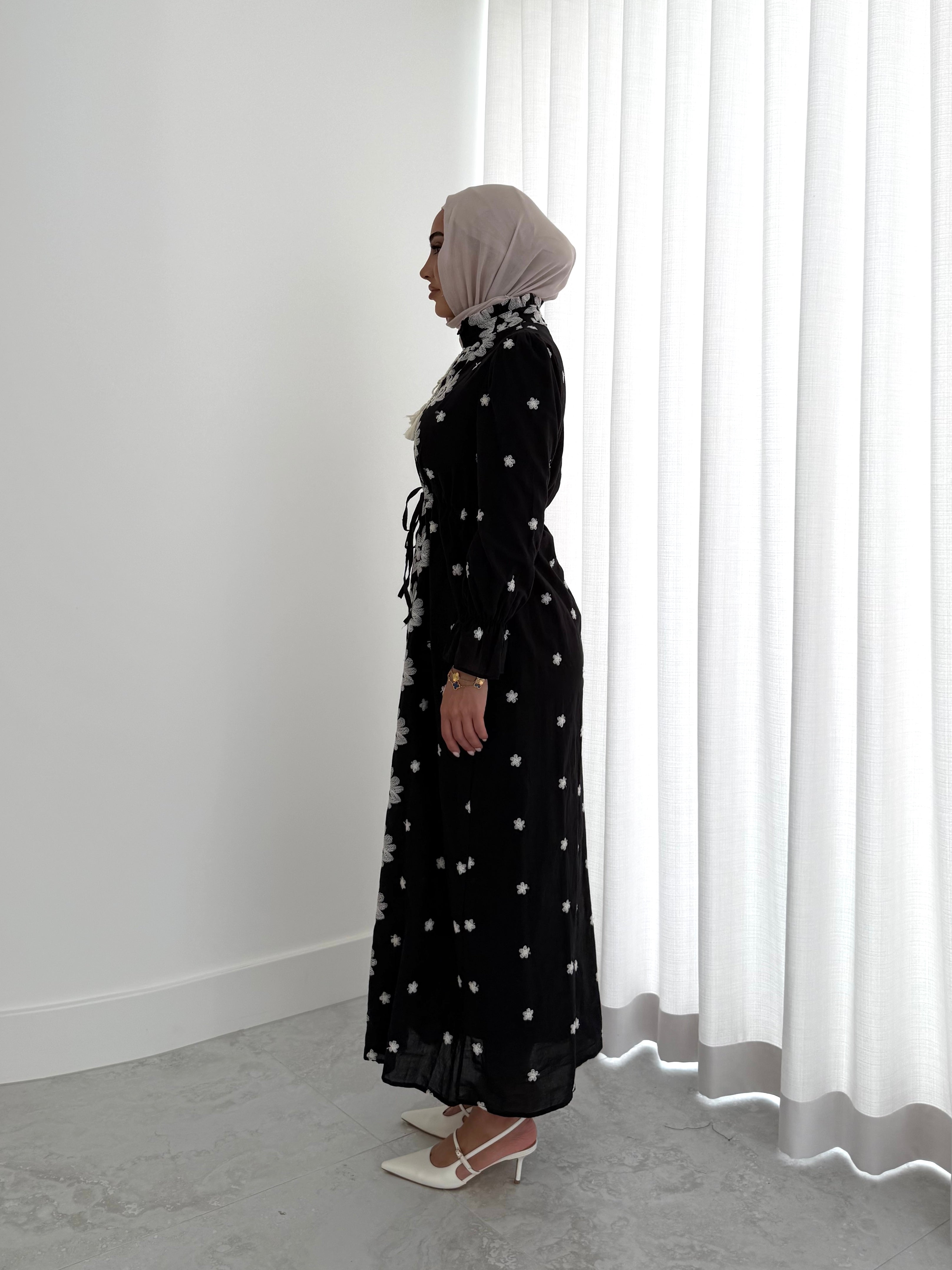 women's modest maxi dress in black and ivory with floral embroidery. dress is lined, long sleeve and lightweight, hijabi friendly and feminine for brunch, party, dinner, events and eid.
