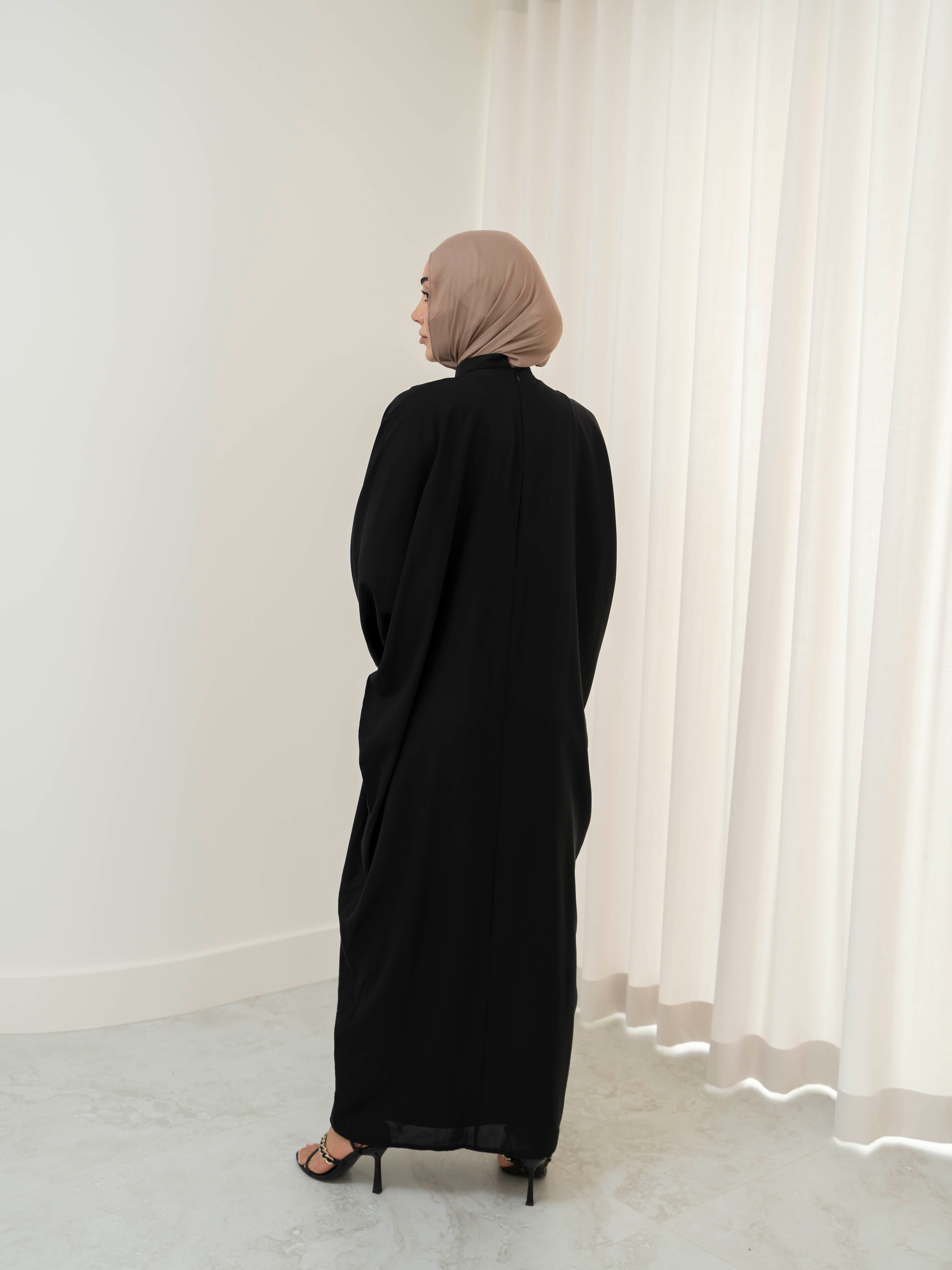 Model wearing the Noor Line abaya featuring a clean silhouette with subtle line detailing, styled for a modest and elegant look suitable for Ramadan and Eid.