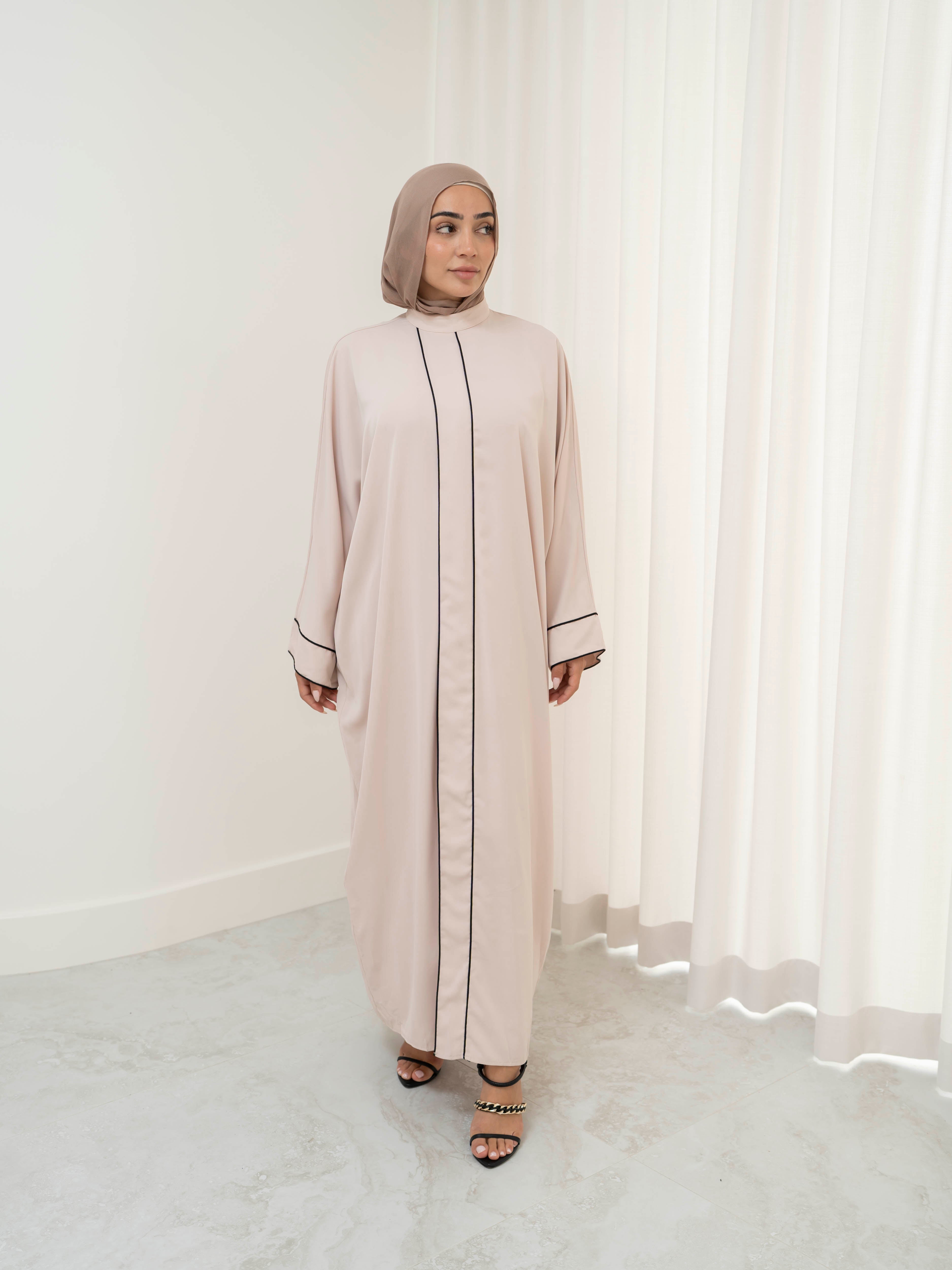 Model wearing the Noor Line abaya featuring a clean silhouette with subtle line detailing, styled for a modest and elegant look suitable for Ramadan and Eid.