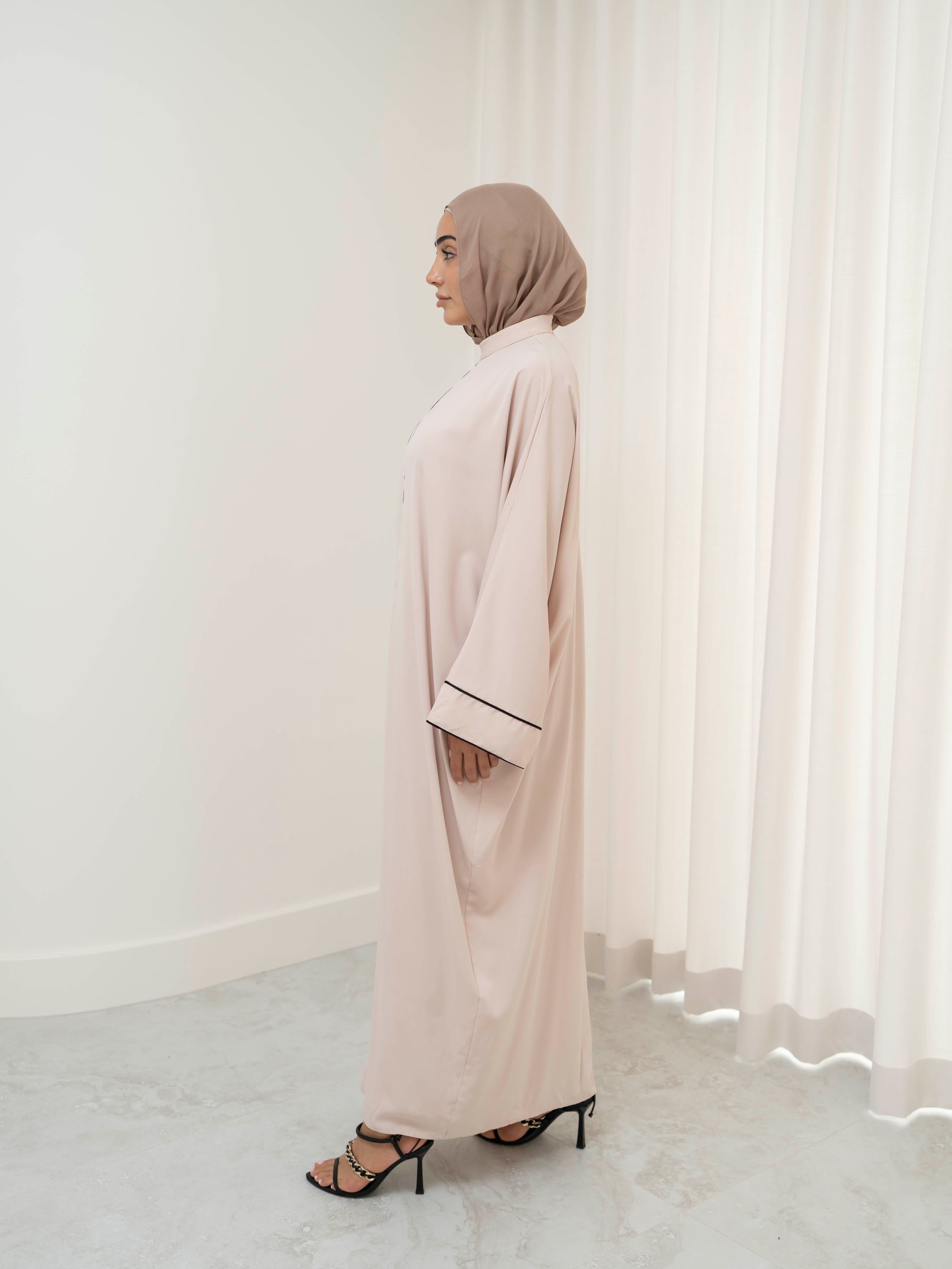 Model wearing the Noor Line abaya featuring a clean silhouette with subtle line detailing, styled for a modest and elegant look suitable for Ramadan and Eid.