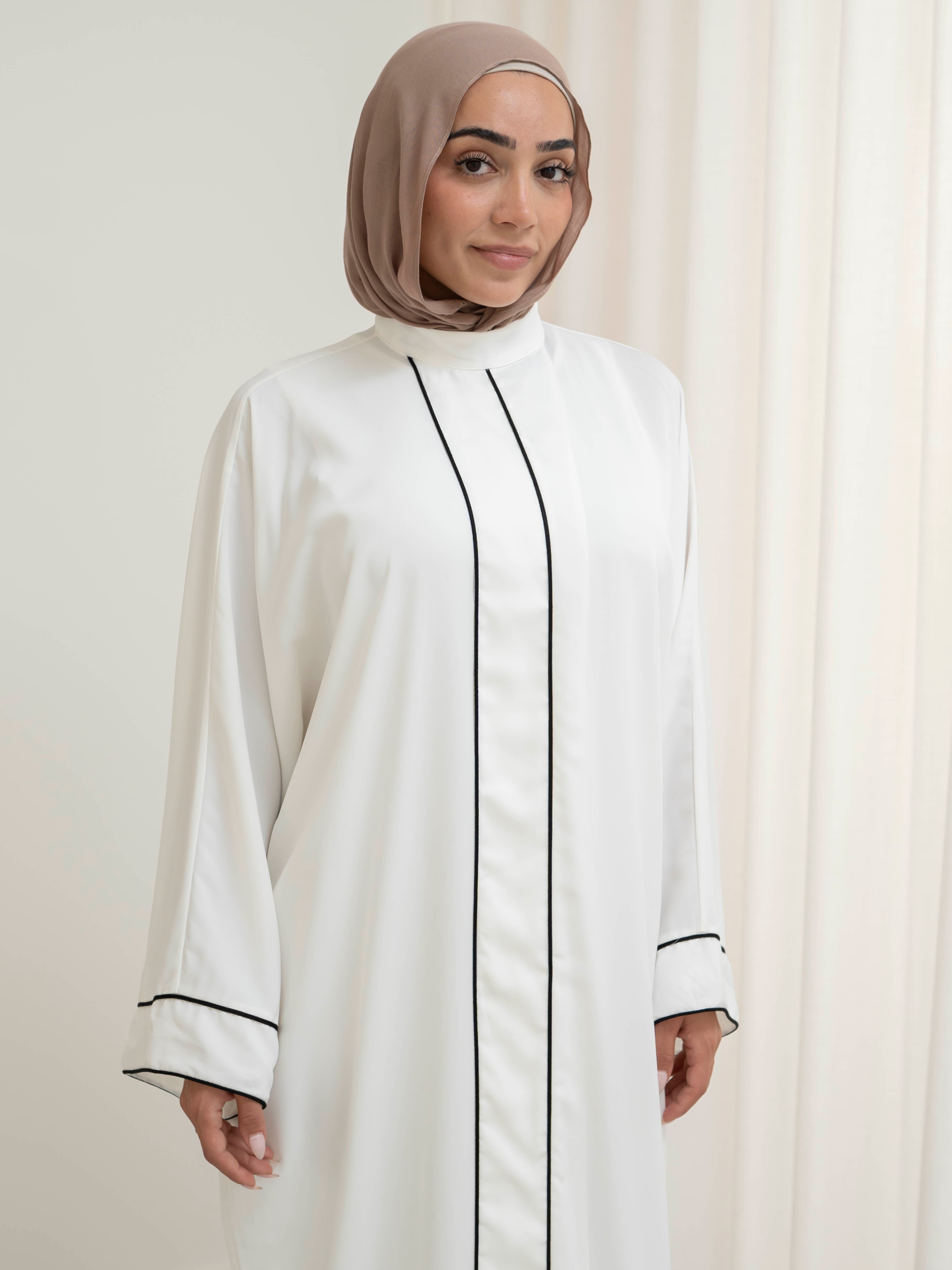 Model wearing the Noor Line abaya featuring a clean silhouette with subtle line detailing, styled for a modest and elegant look suitable for Ramadan and Eid.