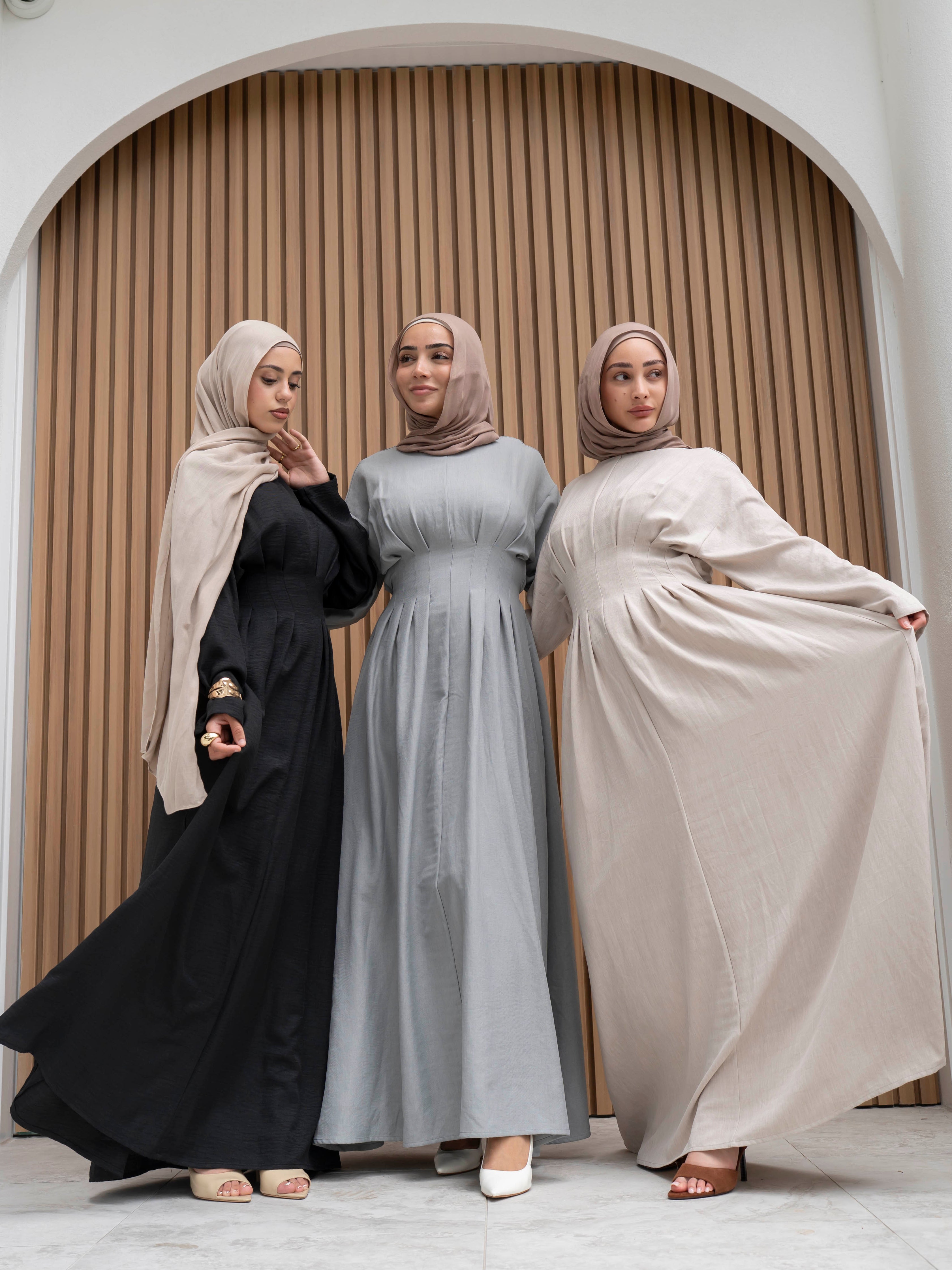 Model wearing the Safa pleated dress featuring a flowing silhouette with soft pleat detailing, styled for a modest and elegant look suitable for Ramadan and Eid.