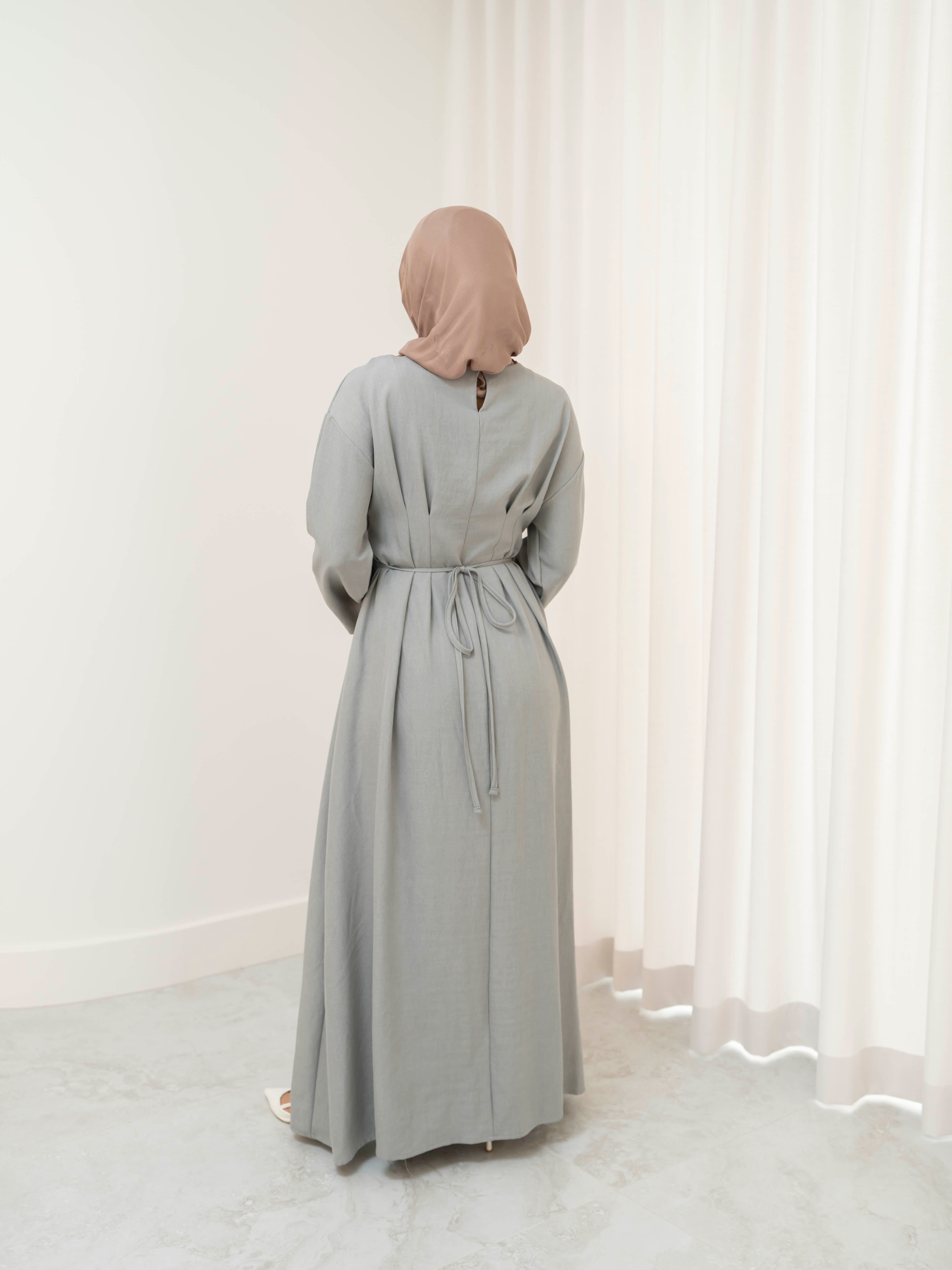 Model wearing the Safa pleated dress featuring a flowing silhouette with soft pleat detailing, styled for a modest and elegant look suitable for Ramadan and Eid.