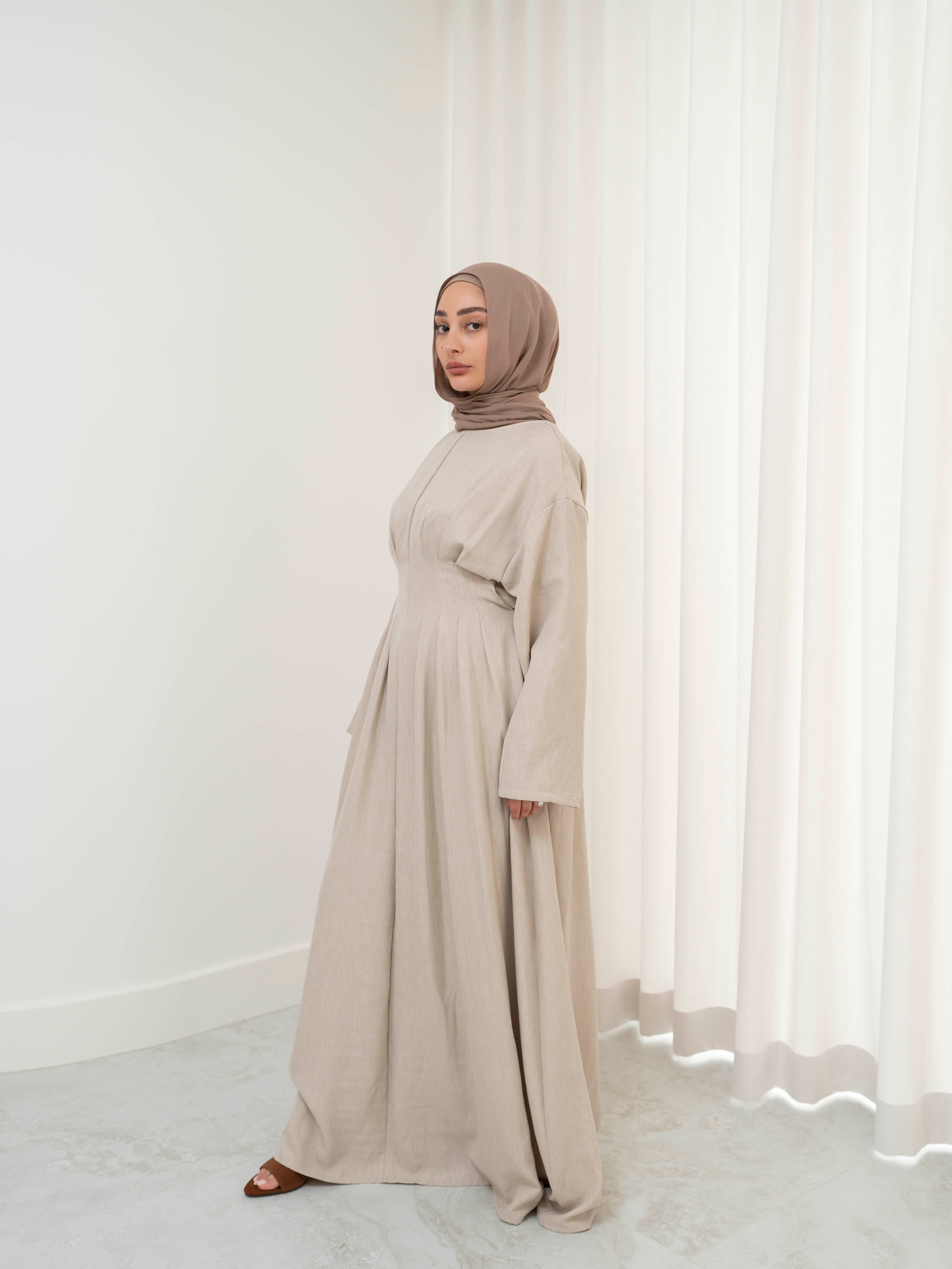 Model wearing the Safa pleated dress featuring a flowing silhouette with soft pleat detailing, styled for a modest and elegant look suitable for Ramadan and Eid.