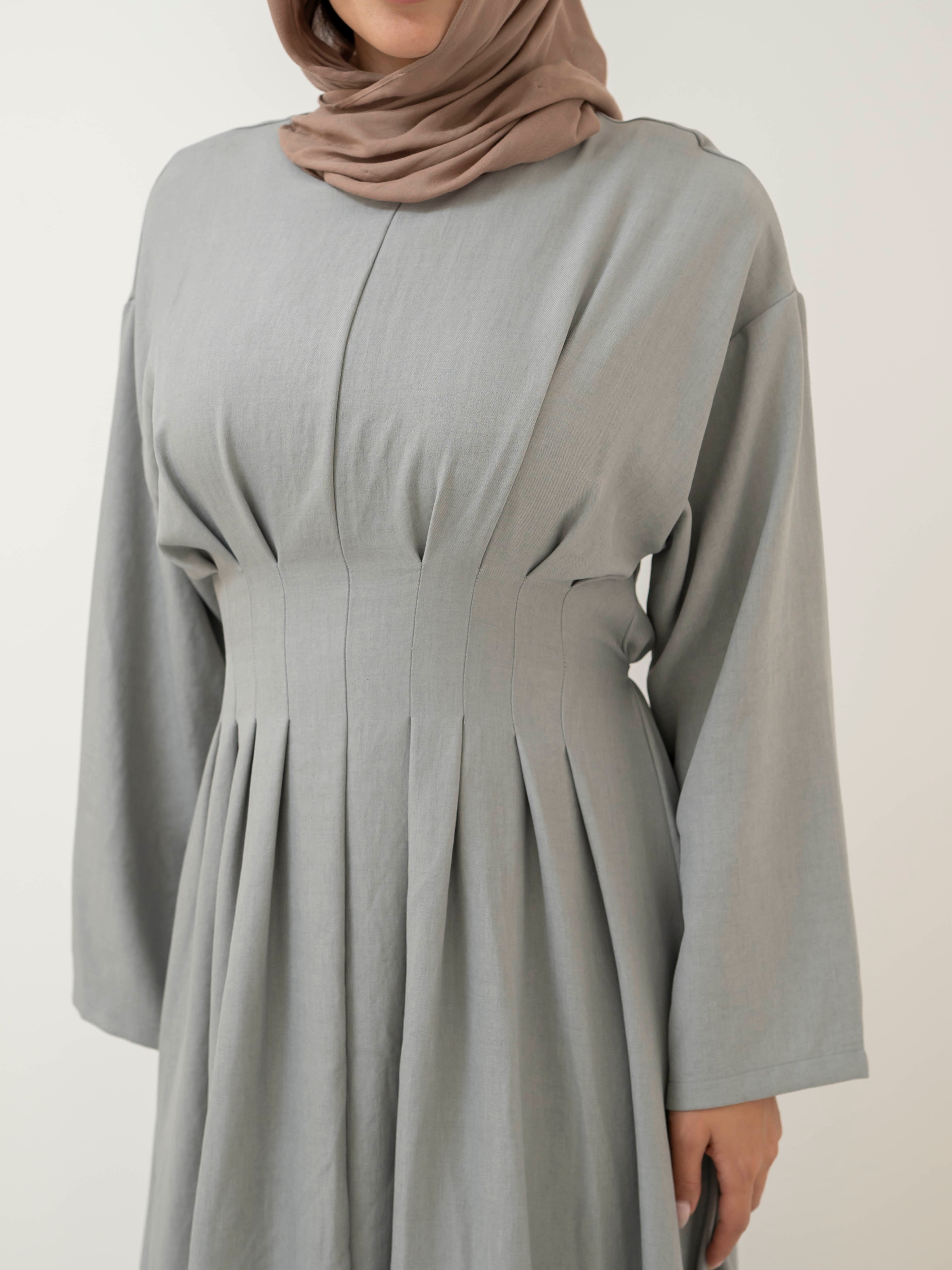 Model wearing the Safa pleated dress featuring a flowing silhouette with soft pleat detailing, styled for a modest and elegant look suitable for Ramadan and Eid.