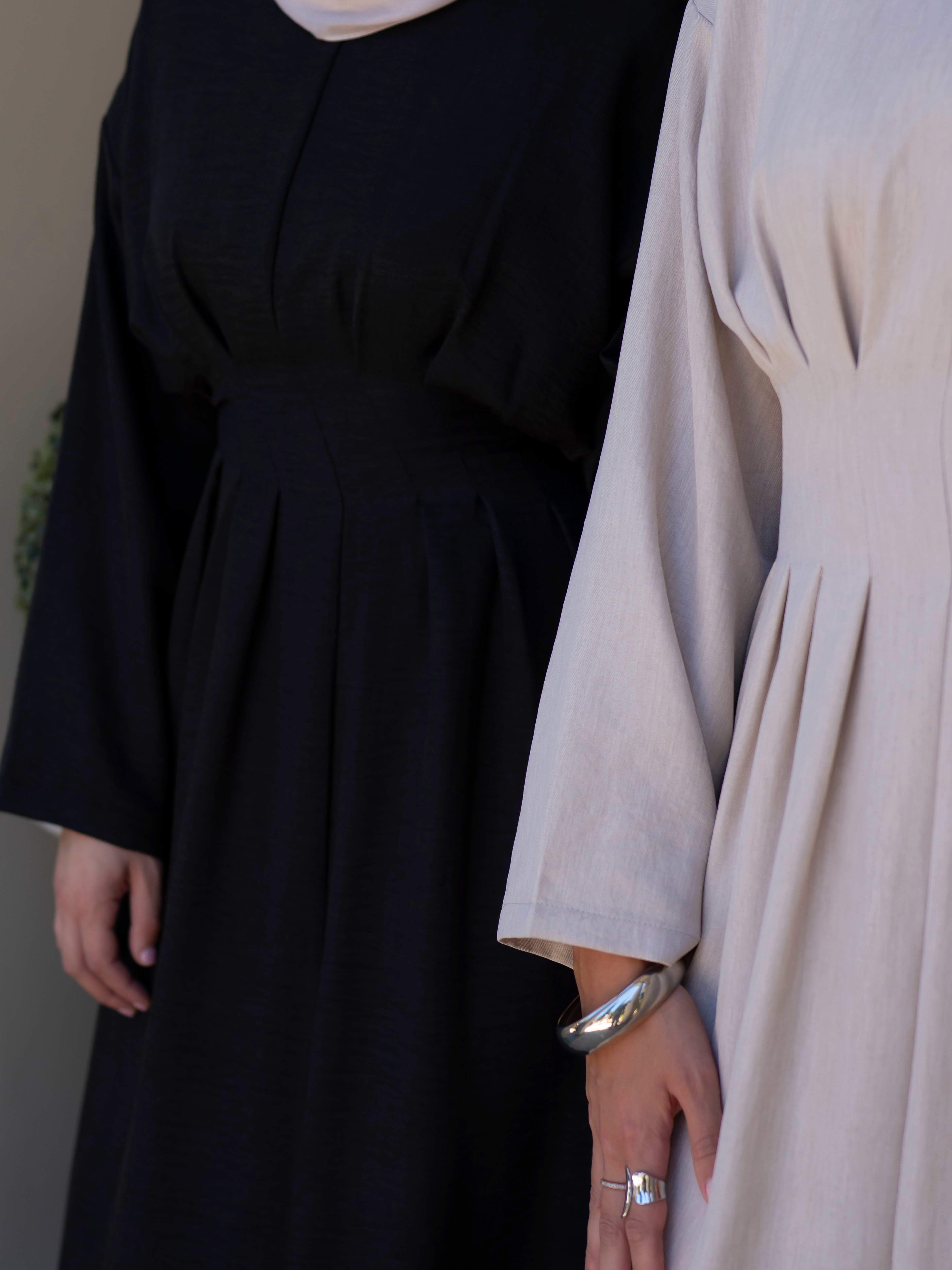 Model wearing the Safa pleated dress featuring a flowing silhouette with soft pleat detailing, styled for a modest and elegant look suitable for Ramadan and Eid.
