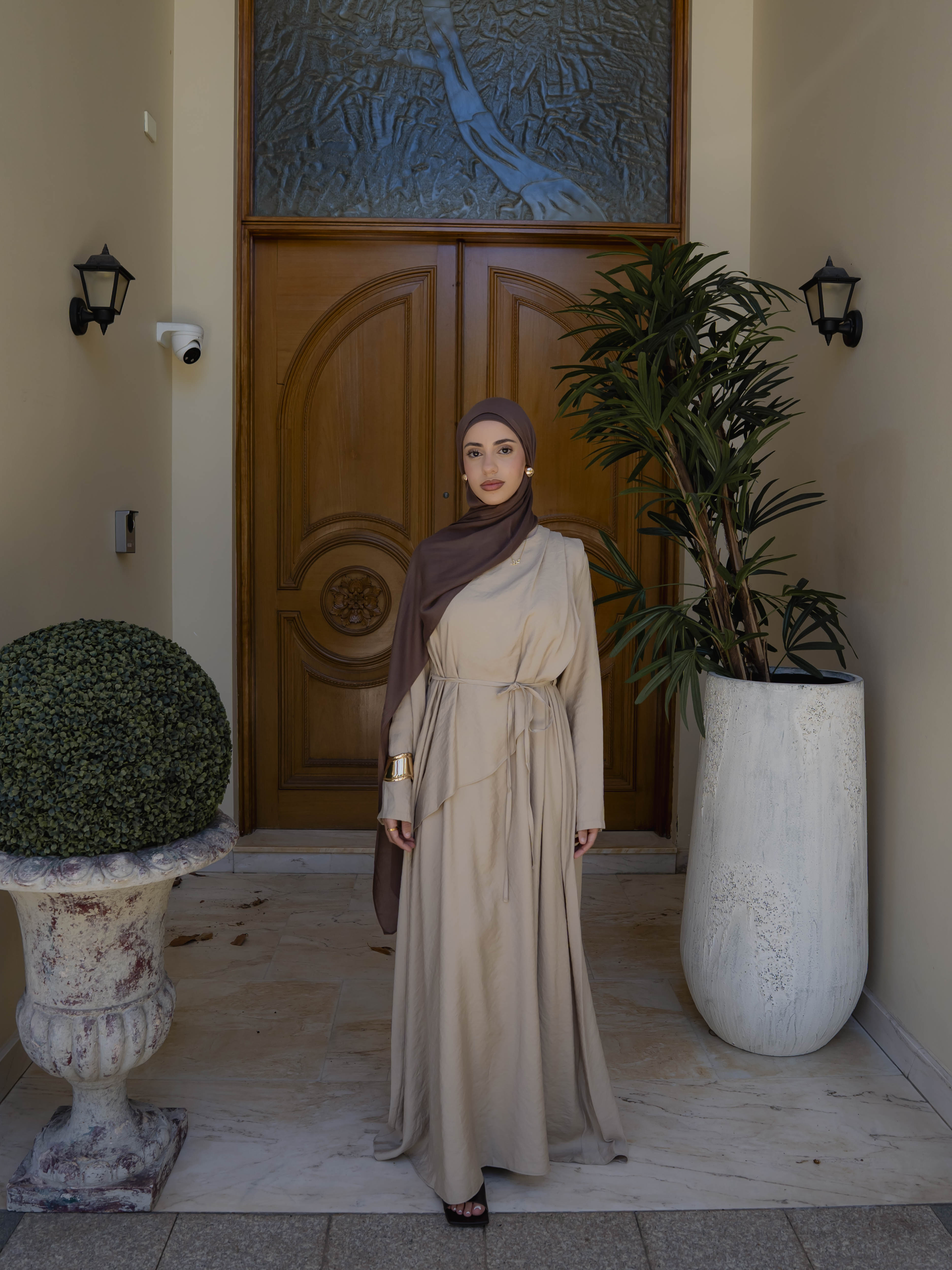 Model wearing the Kareema A-line tie waist dress featuring a flowing silhouette and waist tie detail, styled for a modest and elegant look suitable for Ramadan and Eid.