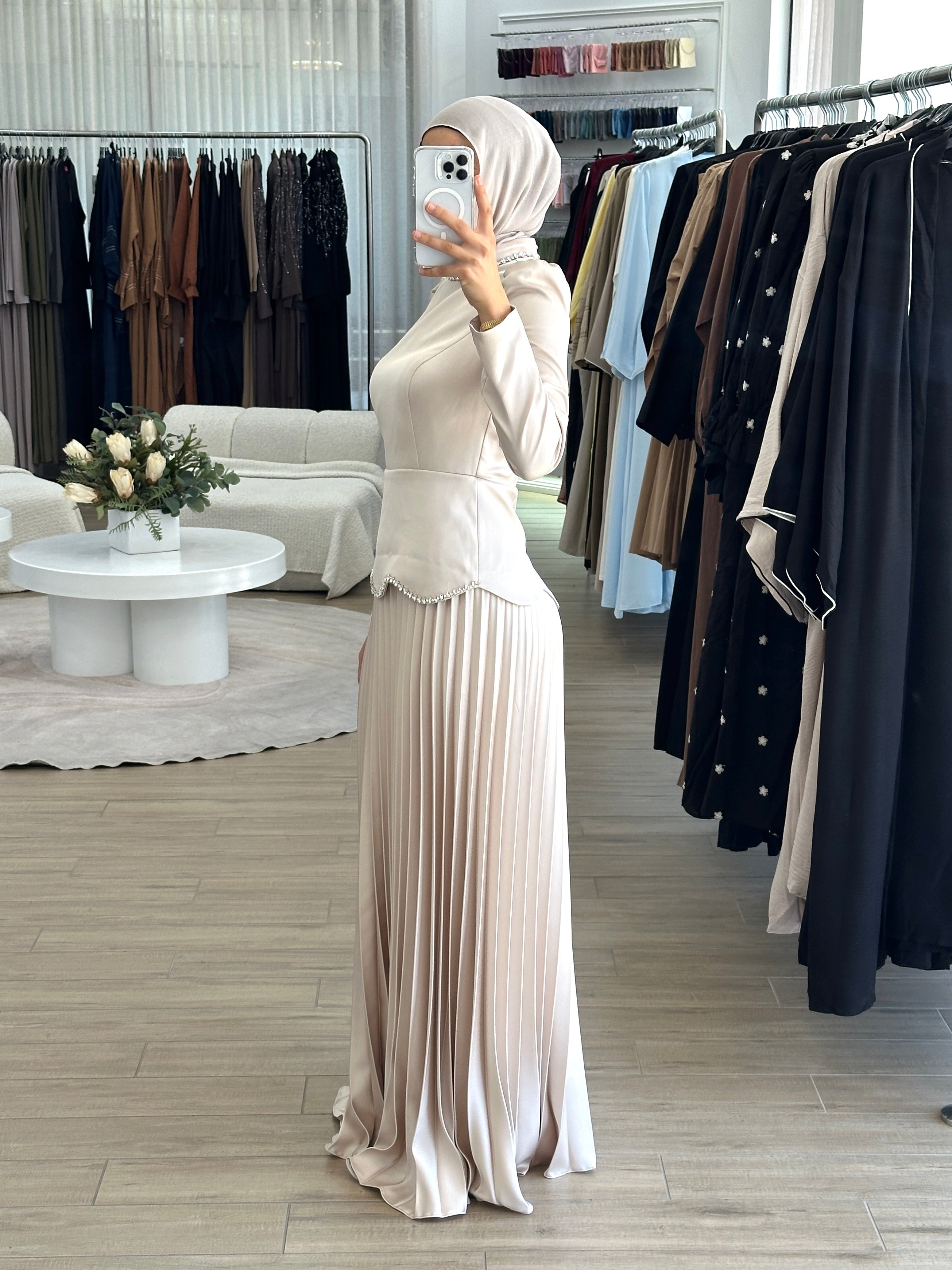 women's maxi full length formal dress with satin bodice and minimal jewel embellishment and satin pleated skirt. Dress is long sleeve, with full coverage and is modest for hijabi fashion. suitable to wear for engagement, wedding, party, formals etc.
