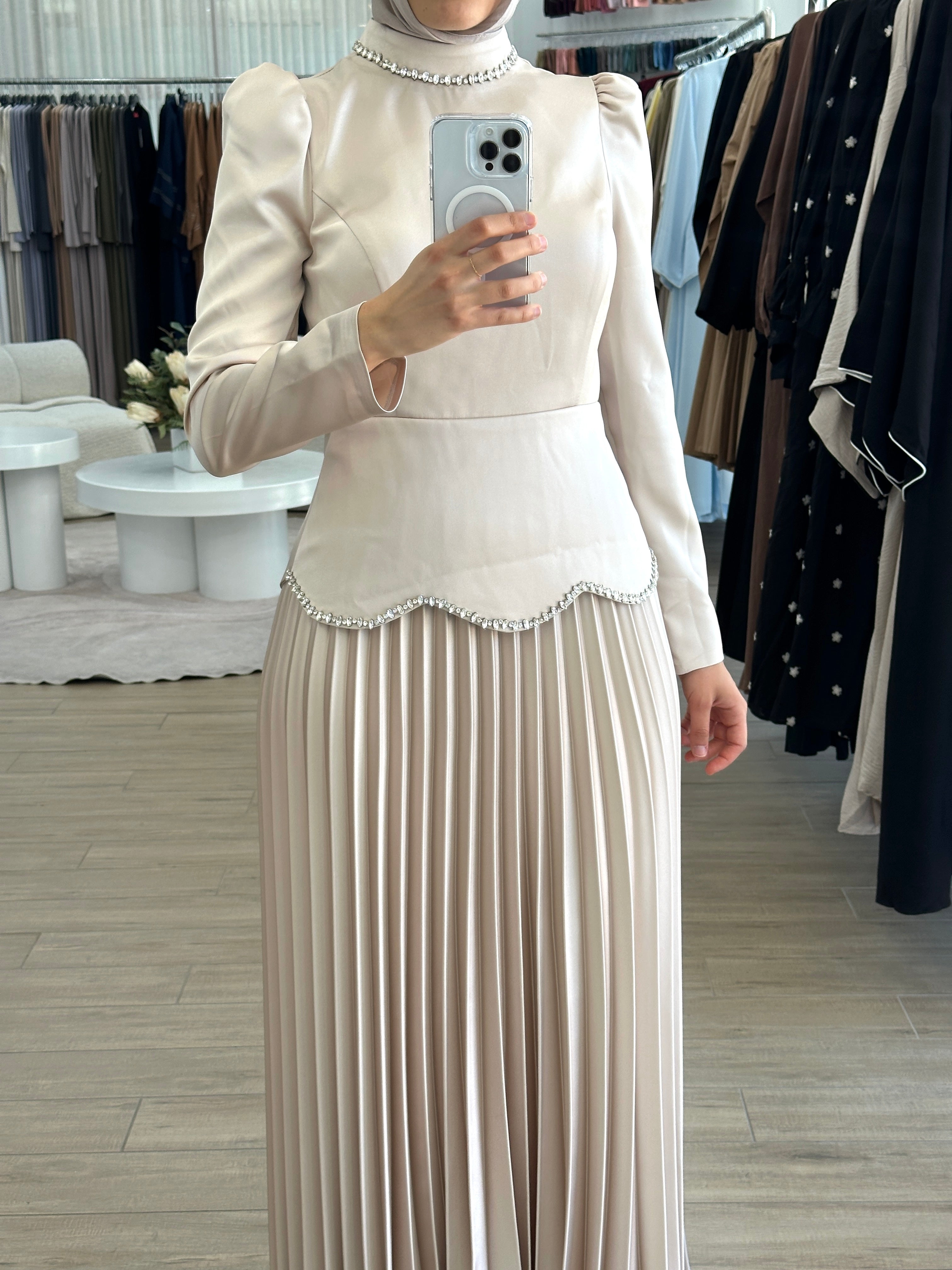 women's maxi full length formal dress with satin bodice and minimal jewel embellishment and satin pleated skirt. Dress is long sleeve, with full coverage and is modest for hijabi fashion. suitable to wear for engagement, wedding, party, formals etc.