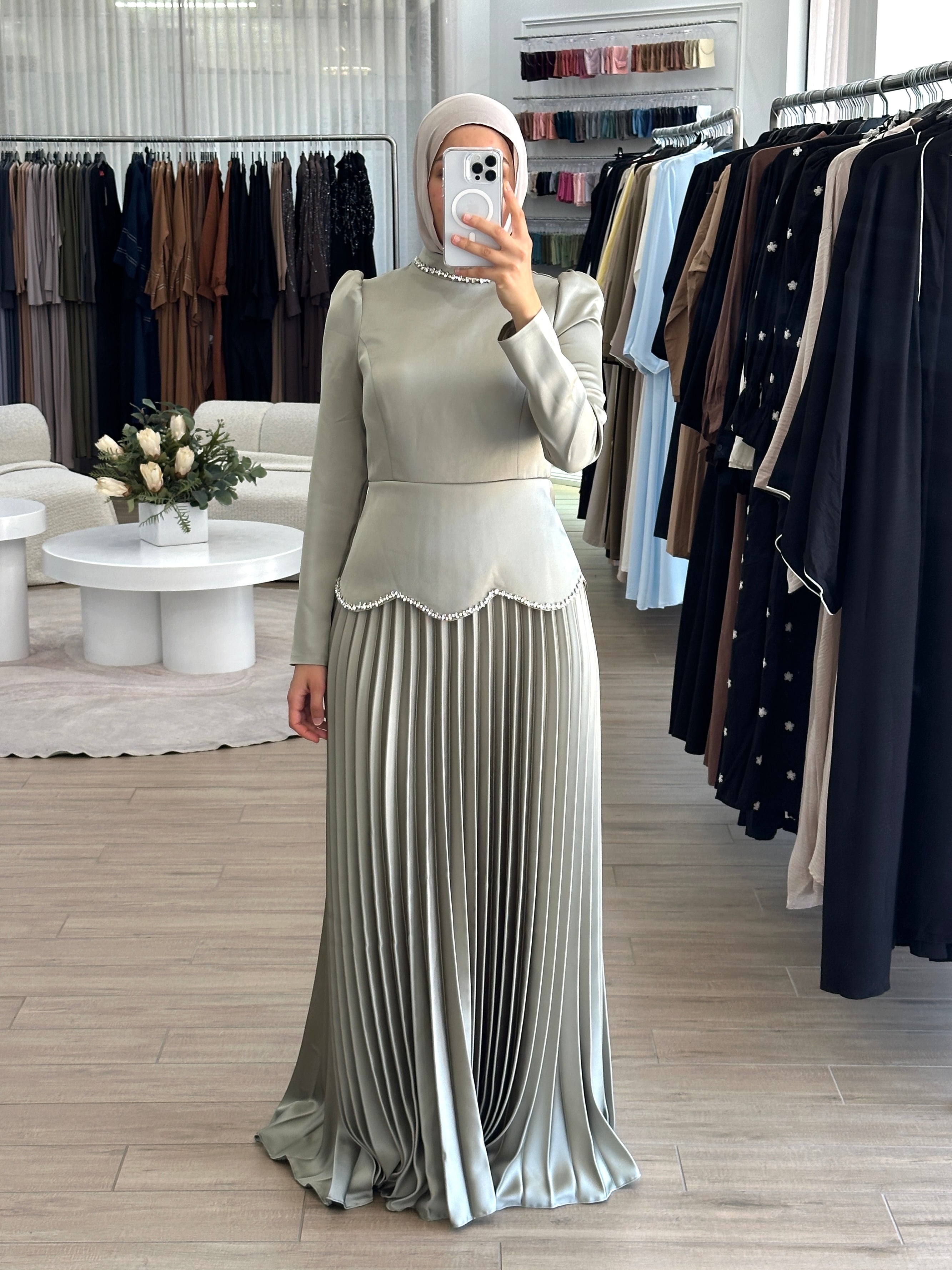 women's maxi full length formal dress with satin bodice and minimal jewel embellishment and satin pleated skirt. Dress is long sleeve, with full coverage and is modest for hijabi fashion. suitable to wear for engagement, wedding, party, formals etc.