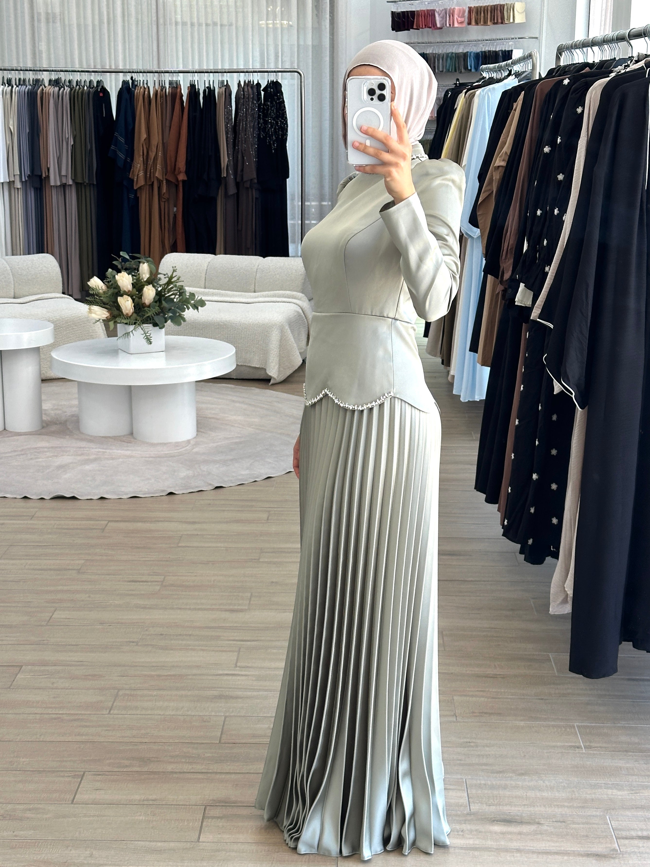 women's maxi full length formal dress with satin bodice and minimal jewel embellishment and satin pleated skirt. Dress is long sleeve, with full coverage and is modest for hijabi fashion. suitable to wear for engagement, wedding, party, formals etc.