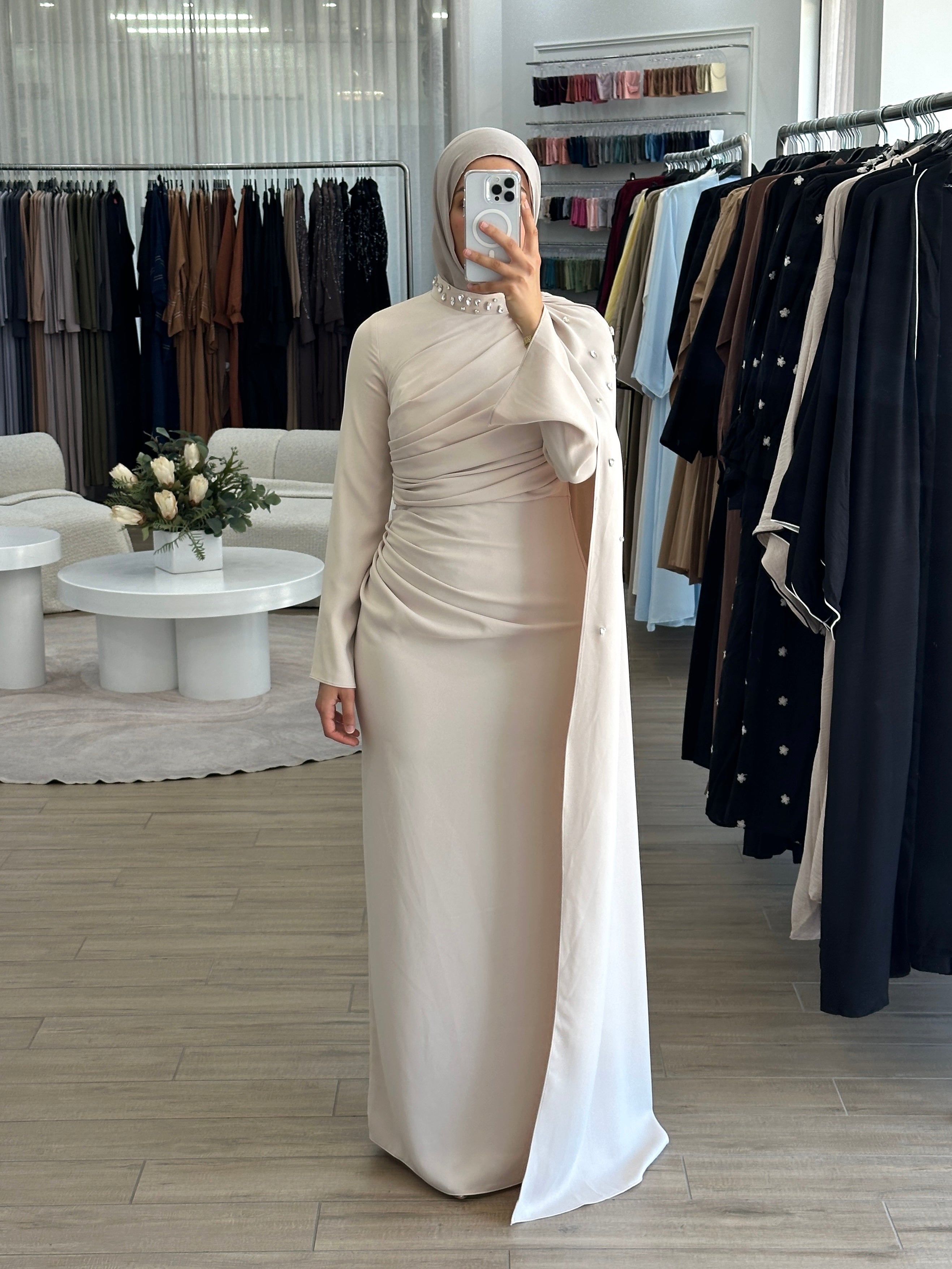 women's full length maxi formal dress in nude with minimal jewel embellishment. Dress is fitted on the waist with ruching and a cape that drapes off the shoulders. elegant to wear to any event/ occasion, suitable for hijabis.