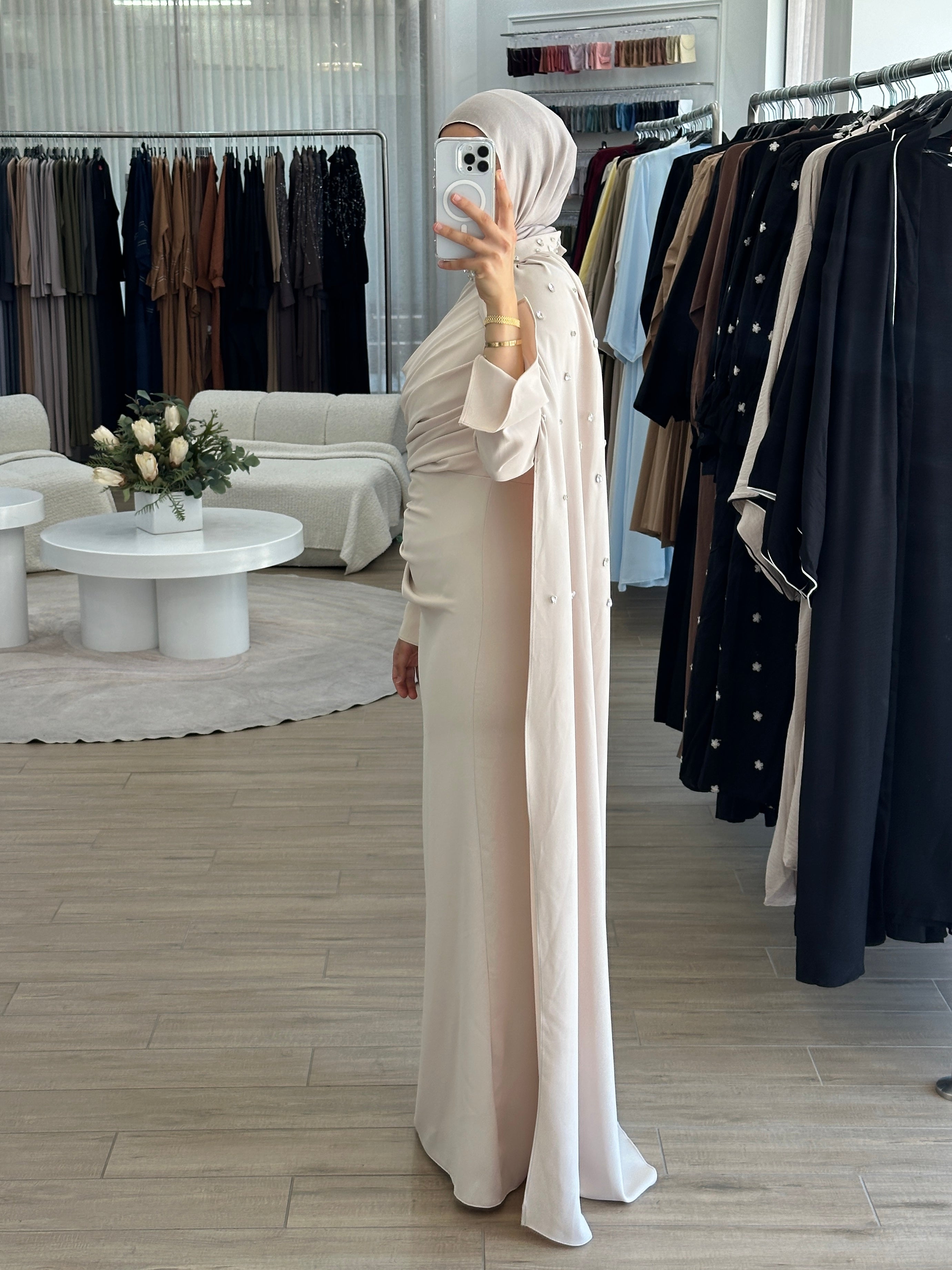 women's full length maxi formal dress in nude with minimal jewel embellishment. Dress is fitted on the waist with ruching and a cape that drapes off the shoulders. elegant to wear to any event/ occasion, suitable for hijabis.