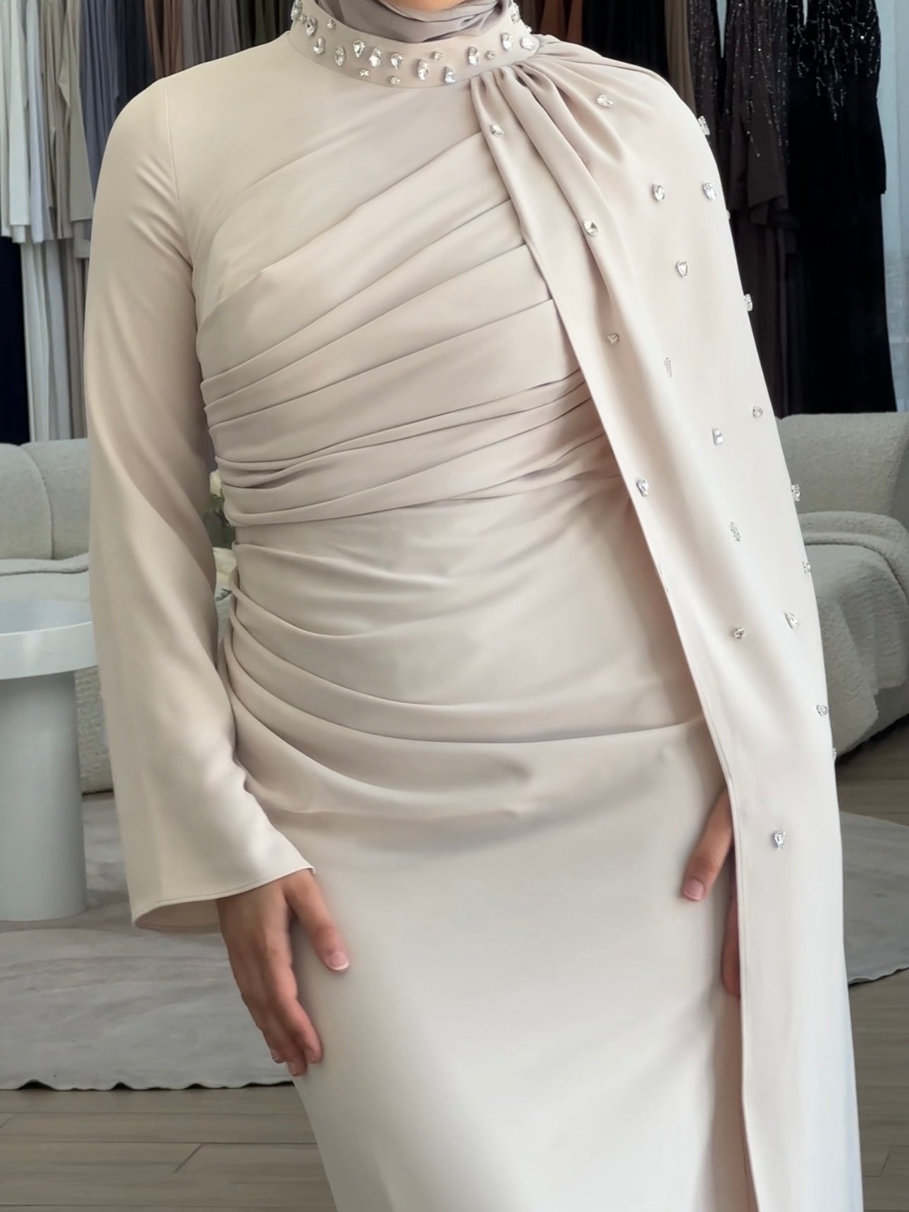 women's full length maxi formal dress in nude with minimal jewel embellishment. Dress is fitted on the waist with ruching and a cape that drapes off the shoulders. elegant to wear to any event/ occasion, suitable for hijabis.