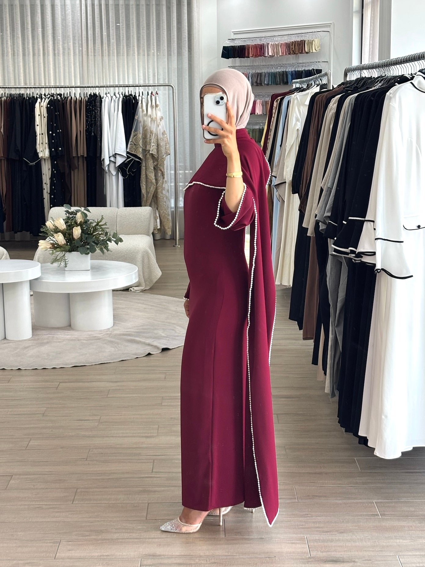 women's formal dress in deep red featuring delicate pearl embellishments and a flowing modest silhouette, perfect for formal occasions.