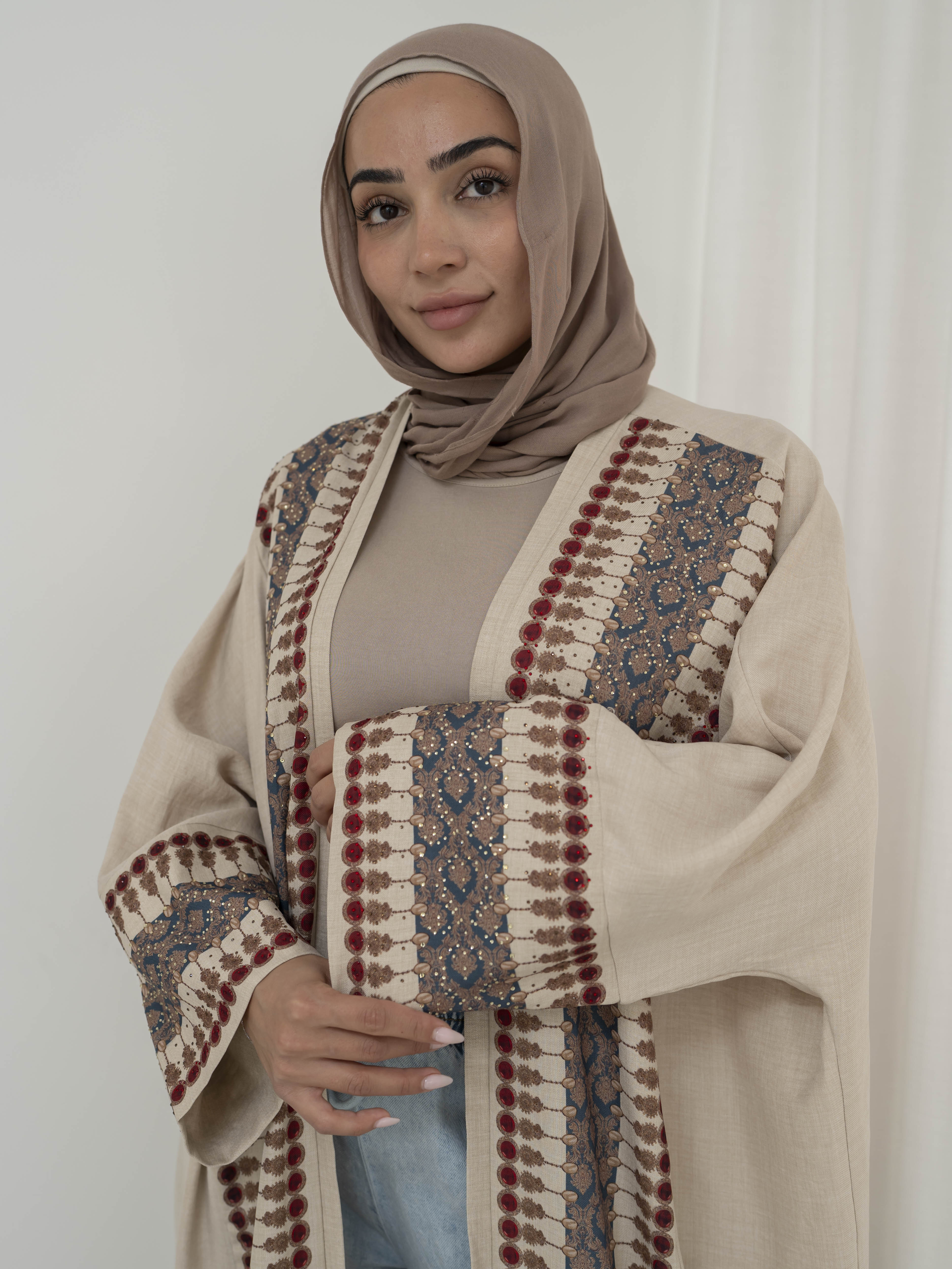 Model wearing the Andalus open abaya with an intricate patterned fabric and subtle embellishments, styled open for a modest and elegant look suitable for Ramadan and Eid.