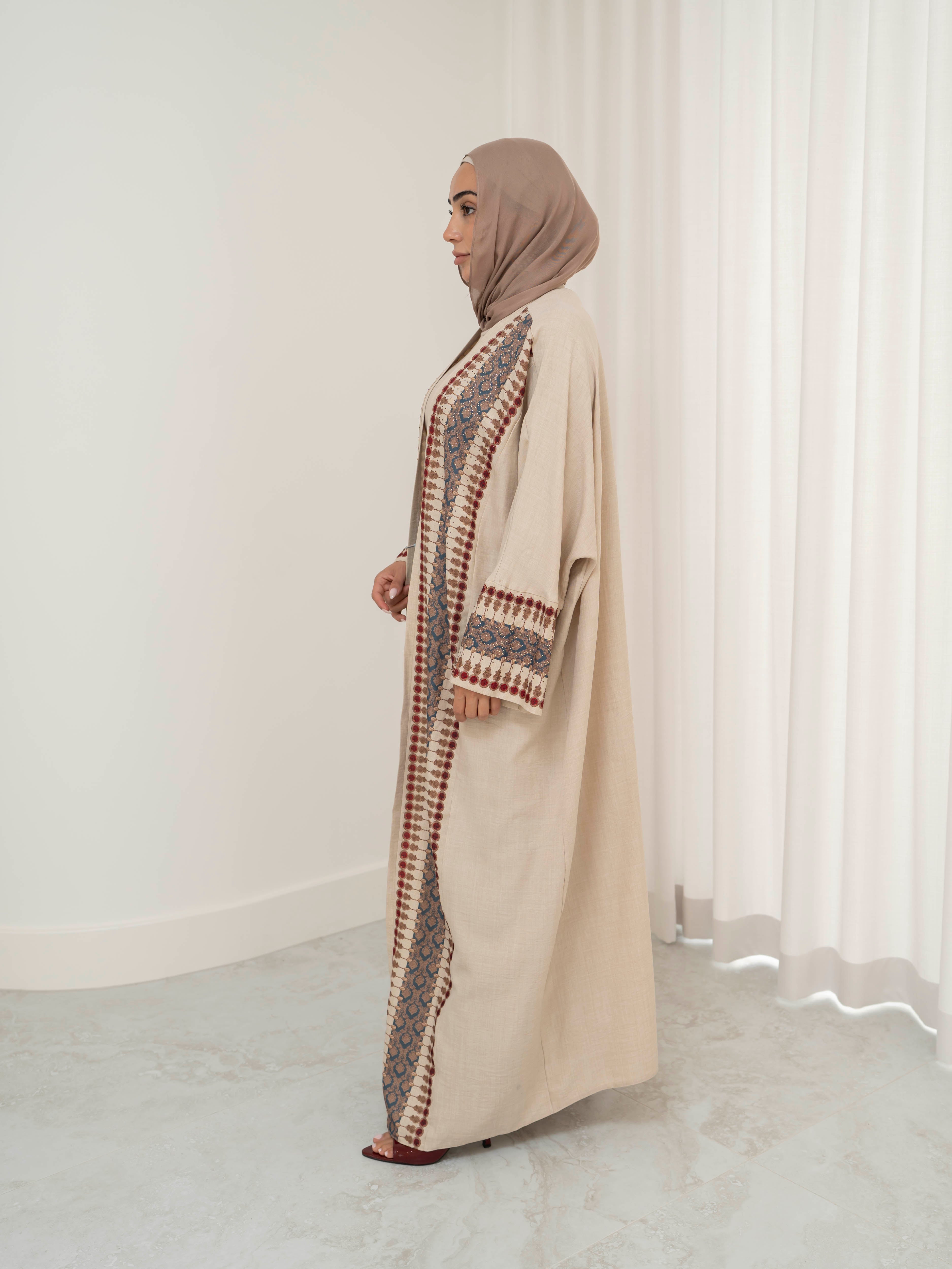 Model wearing the Andalus open abaya with an intricate patterned fabric and subtle embellishments, styled open for a modest and elegant look suitable for Ramadan and Eid.
