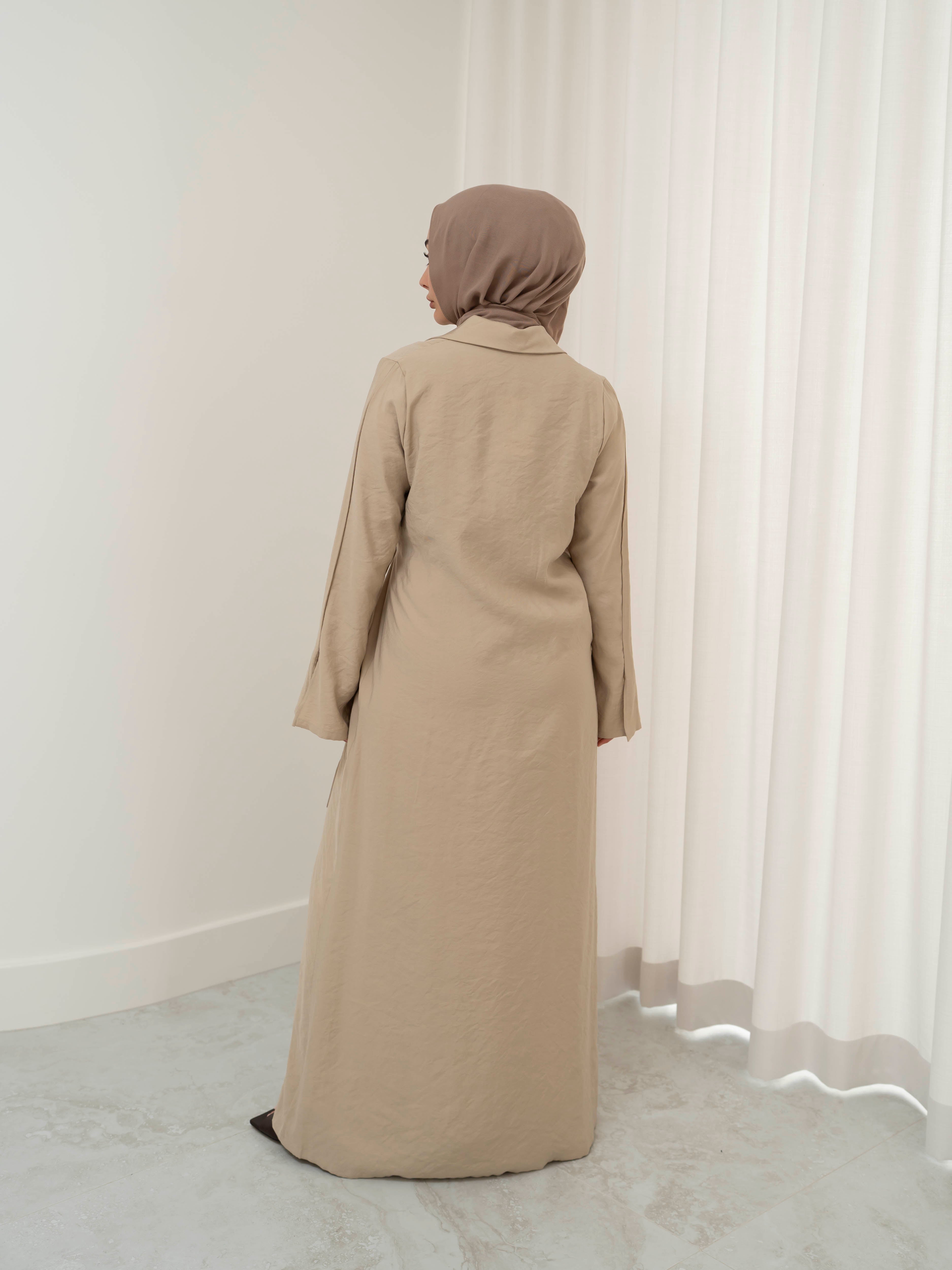 Alya Tie Dress, a full-length dress with adjustable waist tie, lapel neckline, and long sleeves with cuff finish. Lightweight fabric with soft drape, offering a modest, elegant silhouette for Eid, formal occasions, or refined everyday wear.
