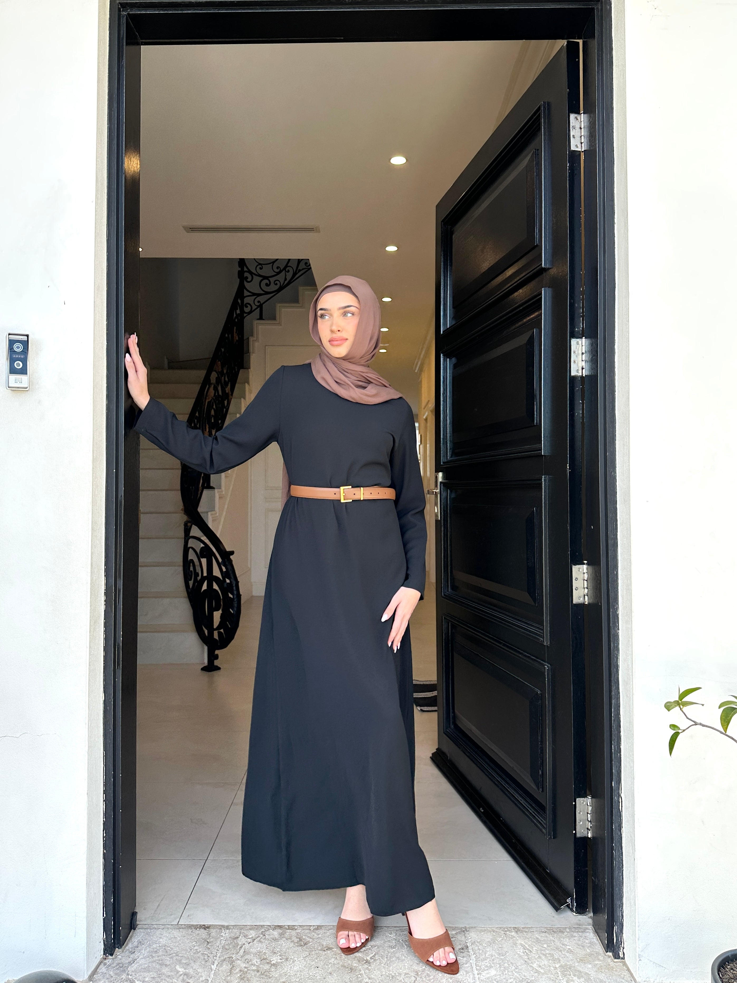 Basic Abaya in a classic straight-cut maxi silhouette with long sleeves and a round neckline. Minimalist design offers modest, polished elegance suitable for everyday wear or special occasions.