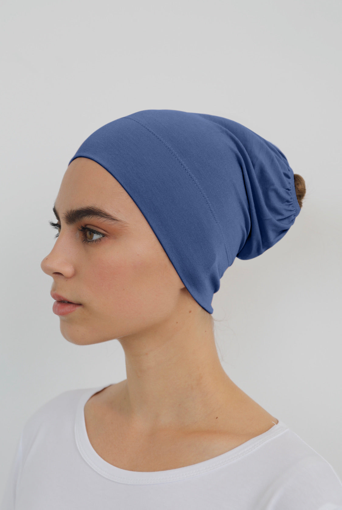 Bamboo under-scarf cap designed to cover hair beneath a hijab, made from soft, breathable natural bamboo fibers with cotton spandex stretch for comfort. Partially closed at the back with an elastic edge to comfortably accommodate hair.