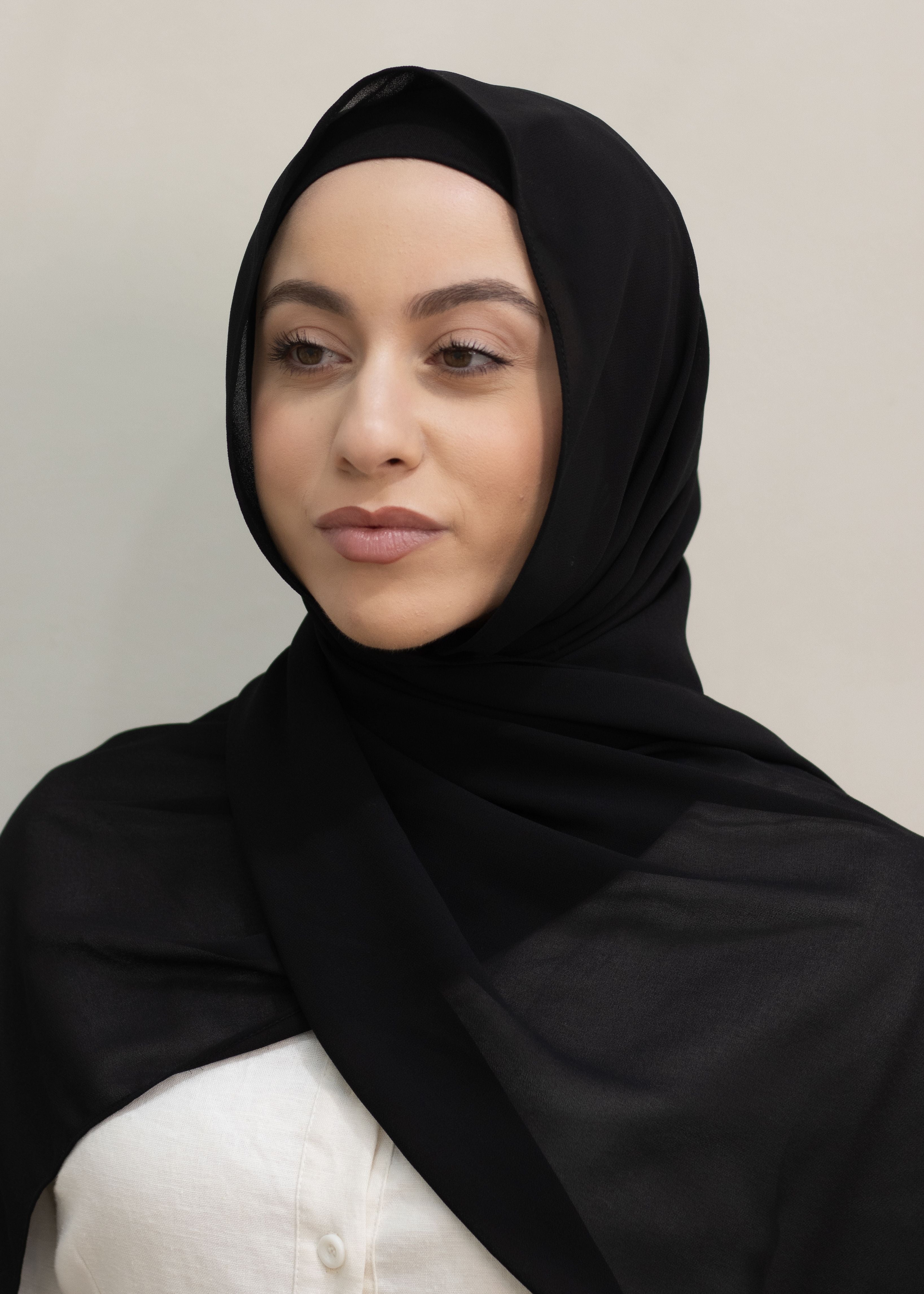 Signature crepe hijab with a soft, flowy drape and slightly higher opacity than chiffon. Features a non-slip finish for secure, comfortable all-day wear. Suitable for everyday use and special occasions. Includes matching open cotton undercap.