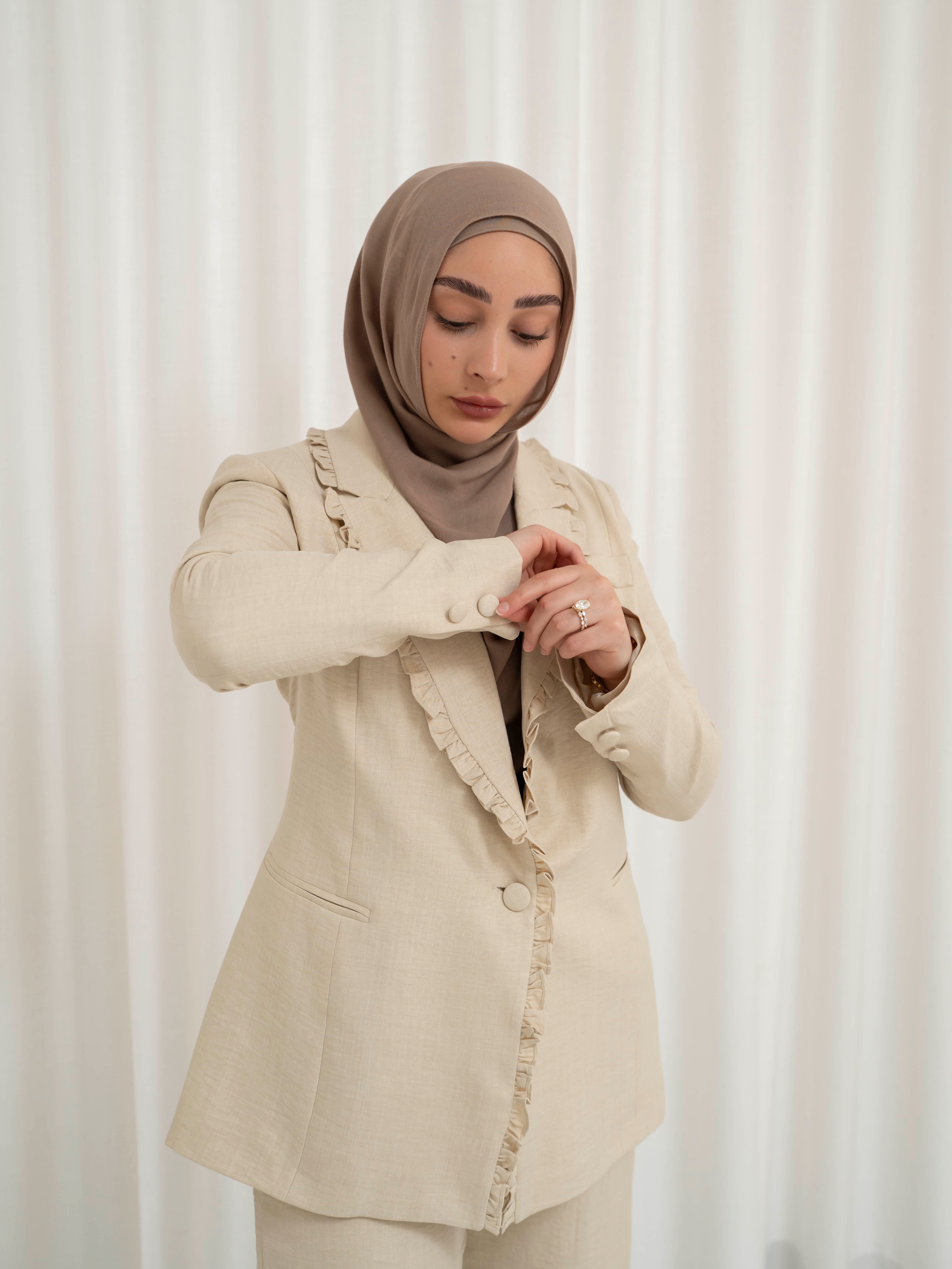 Tailored two-piece blazer and trouser suit set with a structured top and clean lines for a polished, elongated silhouette. Modest yet modern design ideal for formal events, office wear, and elevated everyday styling. Wear together for a statement look or style separately for versatile outfits.