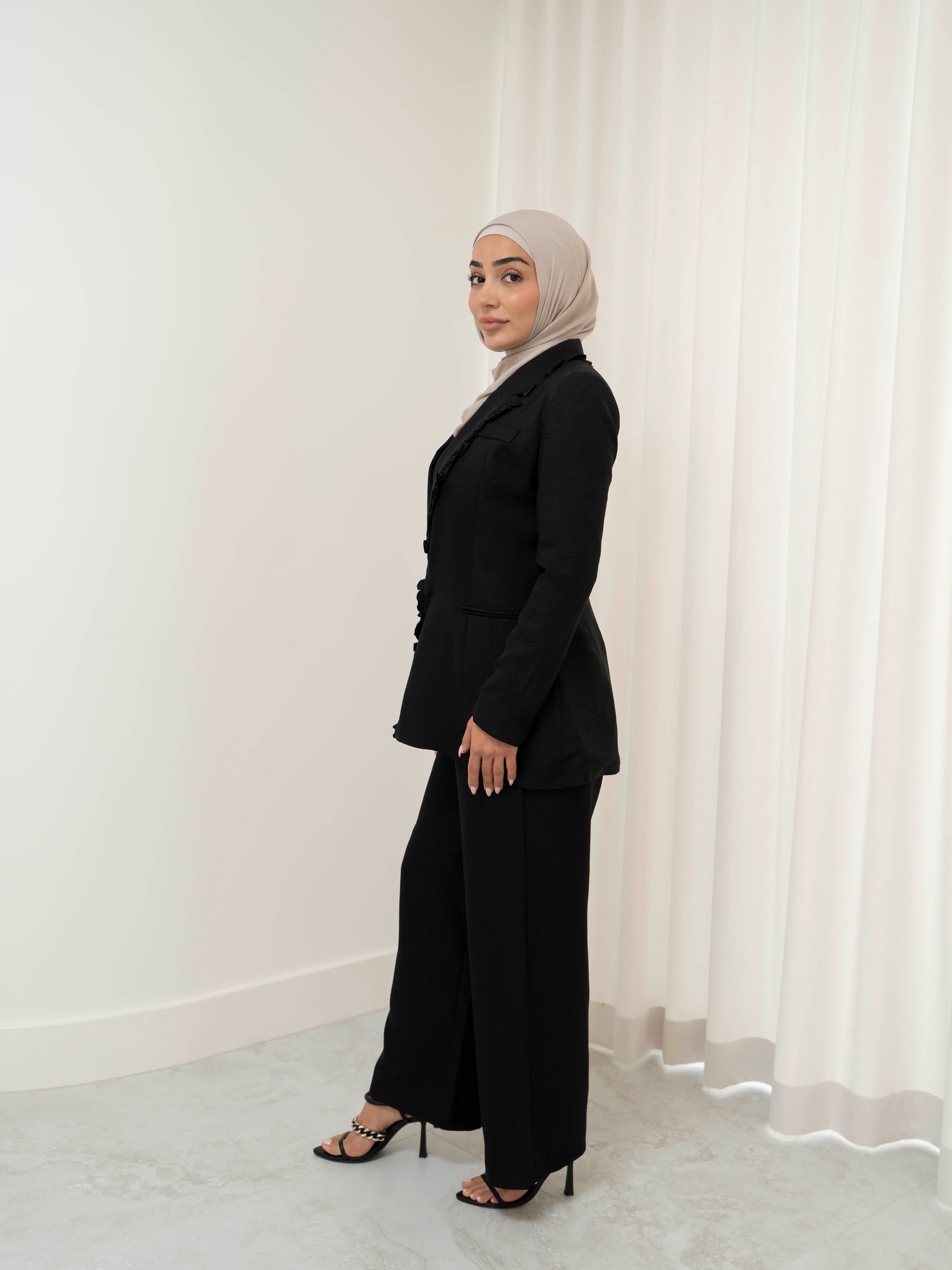 Tailored two-piece blazer and trouser suit set with a structured top and clean lines for a polished, elongated silhouette. Modest yet modern design ideal for formal events, office wear, and elevated everyday styling. Wear together for a statement look or style separately for versatile outfits.