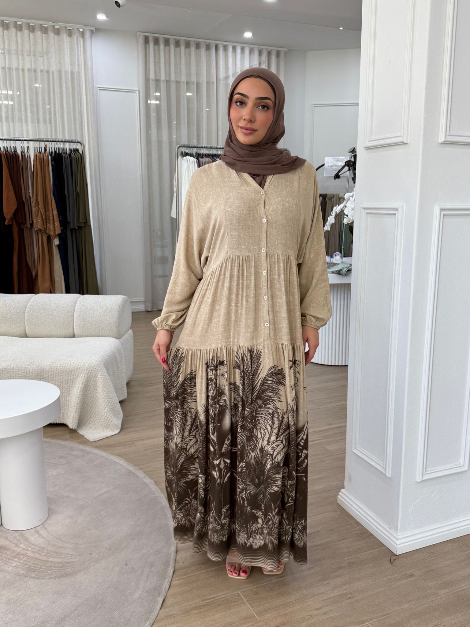 Crafted from breathable cotton, it offers a lightweight feel ideal for warm days while maintaining a modest, refined look.