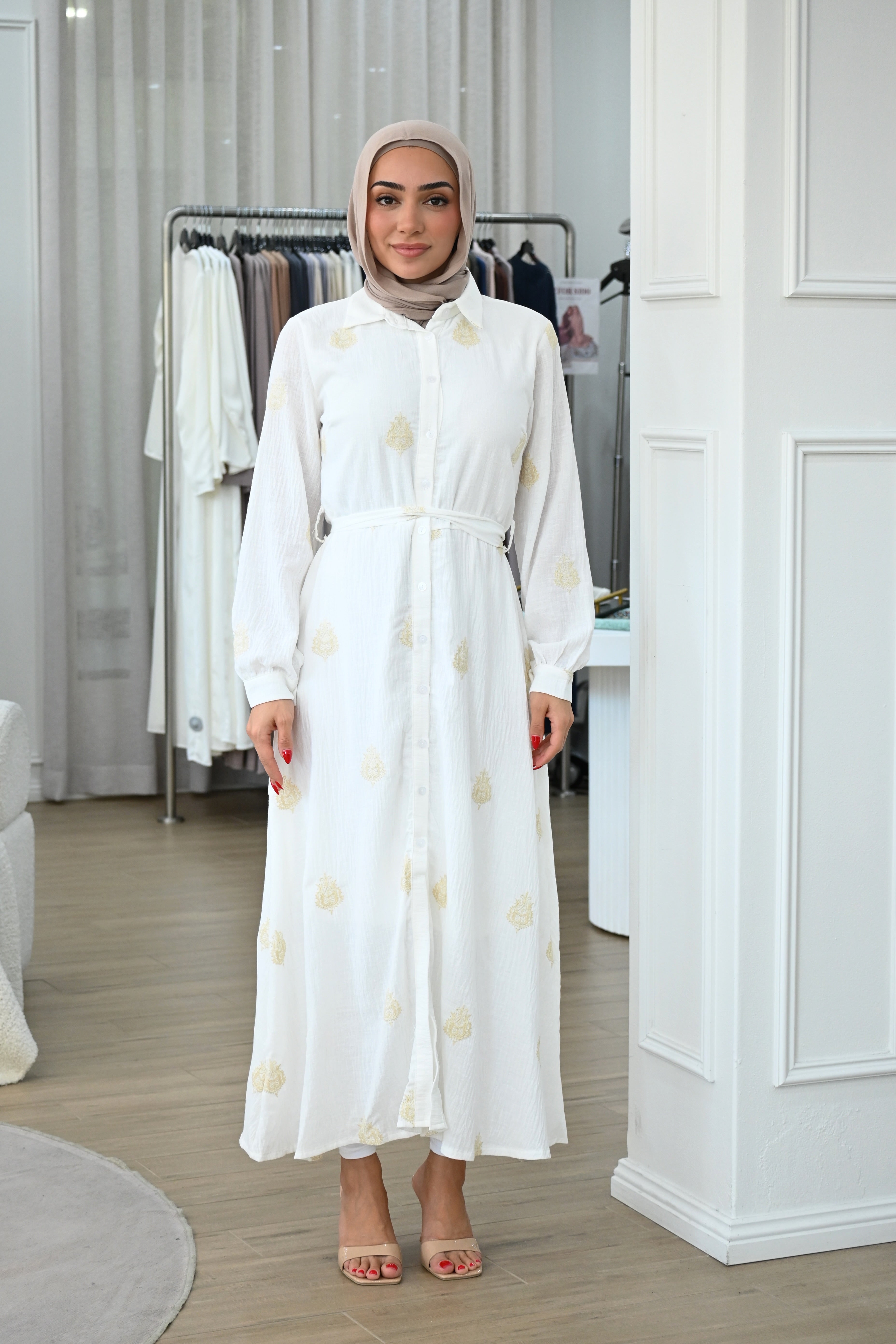 This embroidered shirt dress is designed for comfort without compromising on style. Crafted from a lightweight, breathable fabric, it features delicate tonal embroidery throughout for a refined, elevated finish