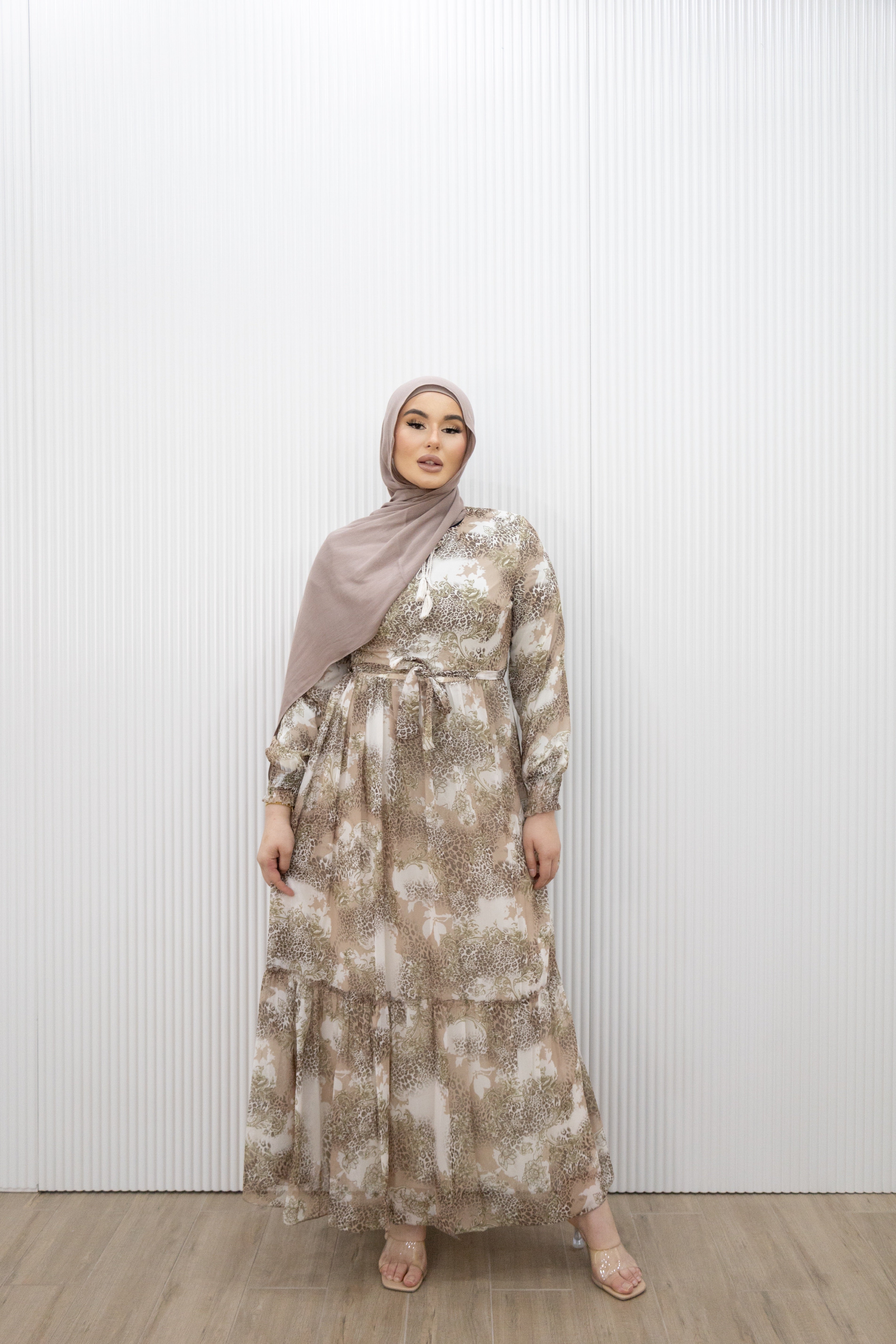 Capture a beautiful bohemian style in the HAJAR PRINTED DRESS Featuring a soft pink print, it has a round neck that fastens with tassel ties then falls to a flourishing skirt with a ruffle hem panel. Use the detachable waist tie to create a flattering shape.