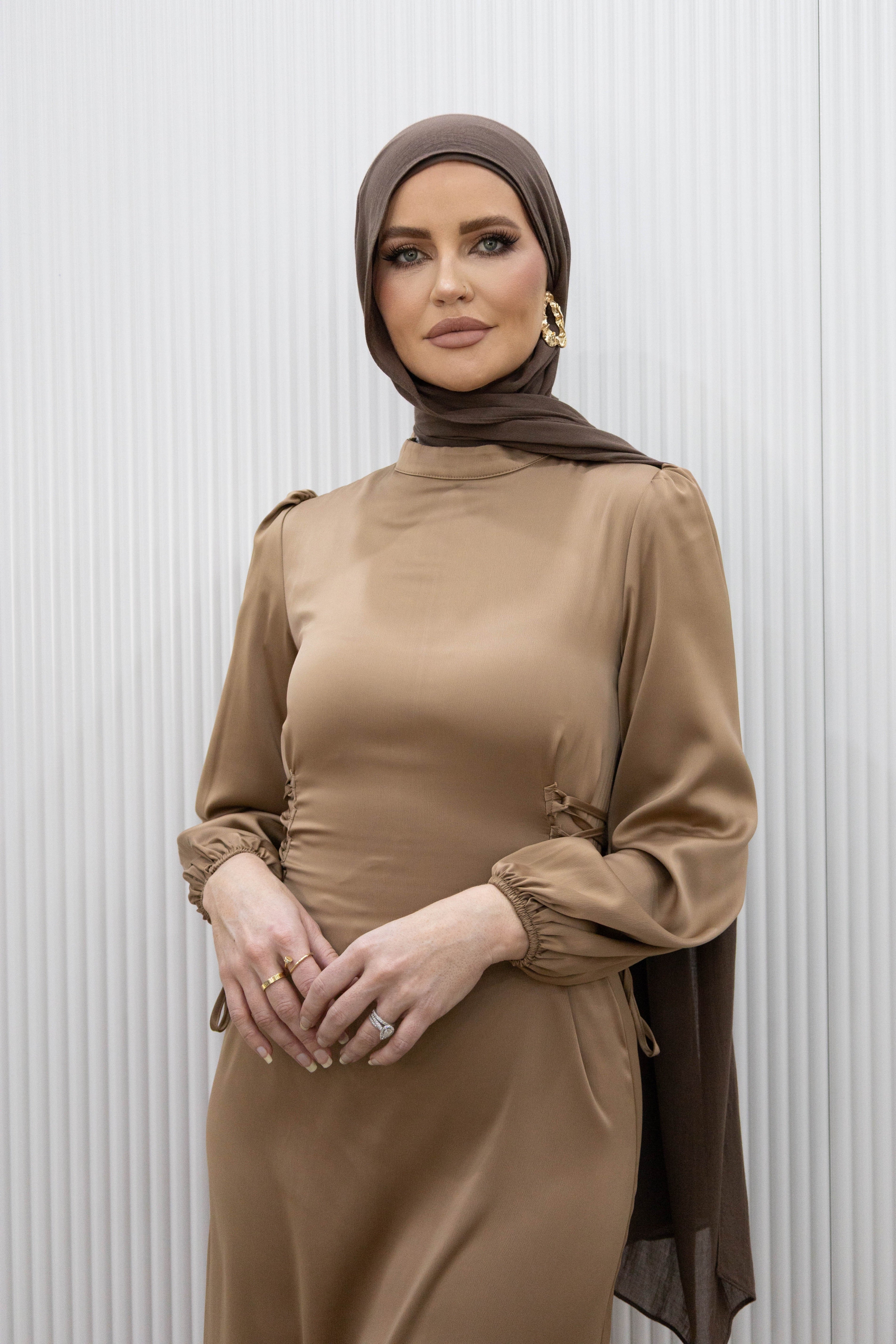 Channel an effortlessly simple elegance with our HANA SATIN DRESS. This midi dress boasts a fitted bodice and long blouson sleeves for a flattering silhouette. The lace ties at the back cinch in the waist, while the ankle length hem highlights a statement heel. Whether it's a dinner date or a girls night out, this dress is the perfect choice.