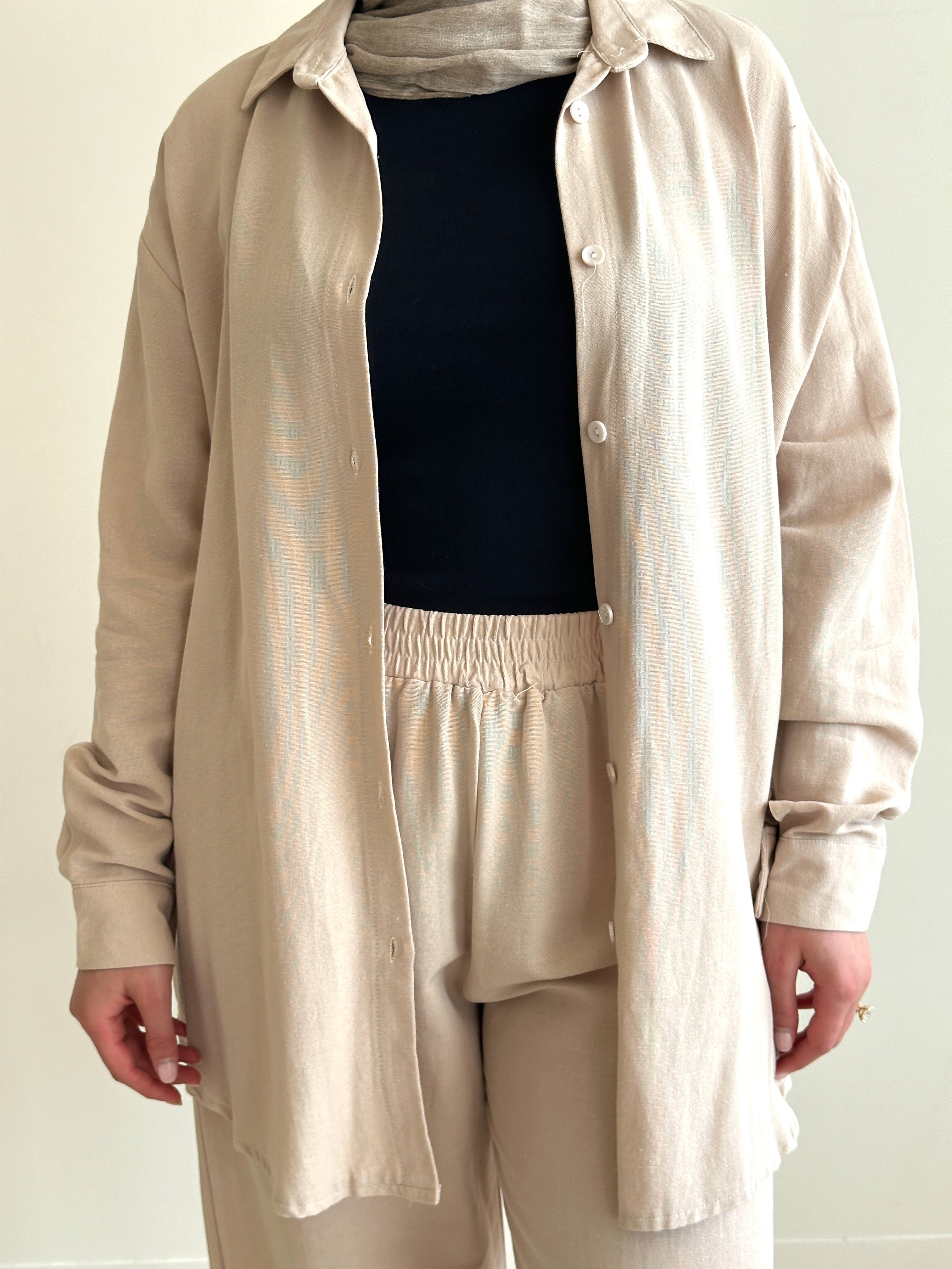 Designed for versatile styling, this set pairs a modest top with a matching pant