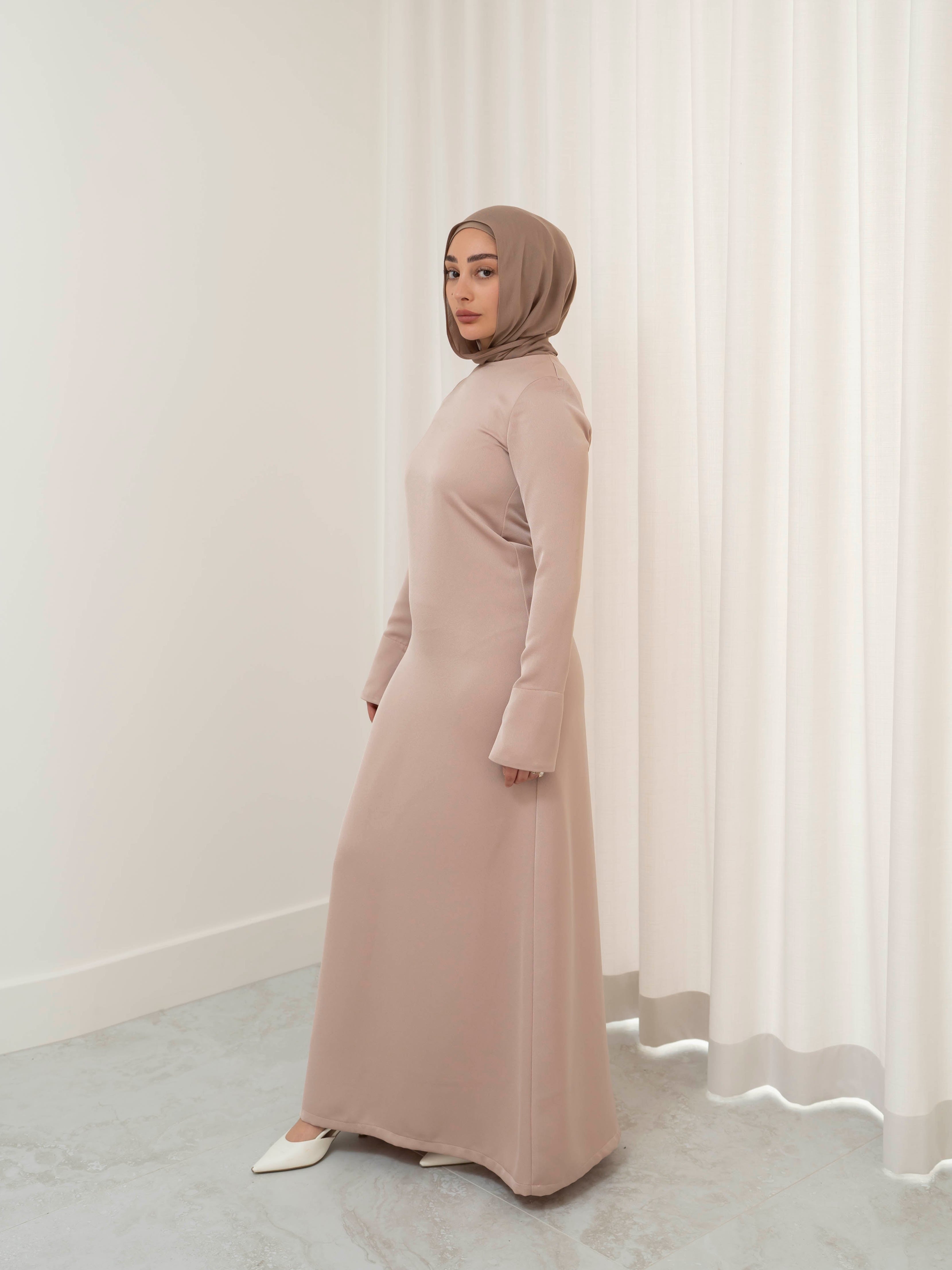 Lumière Satin Dress in smooth, fully lined satin with a soft sheen, featuring a modest, timeless cut and fluid drape that creates an elegant silhouette. Ideal for formal events, evening occasions, and special celebrations.
