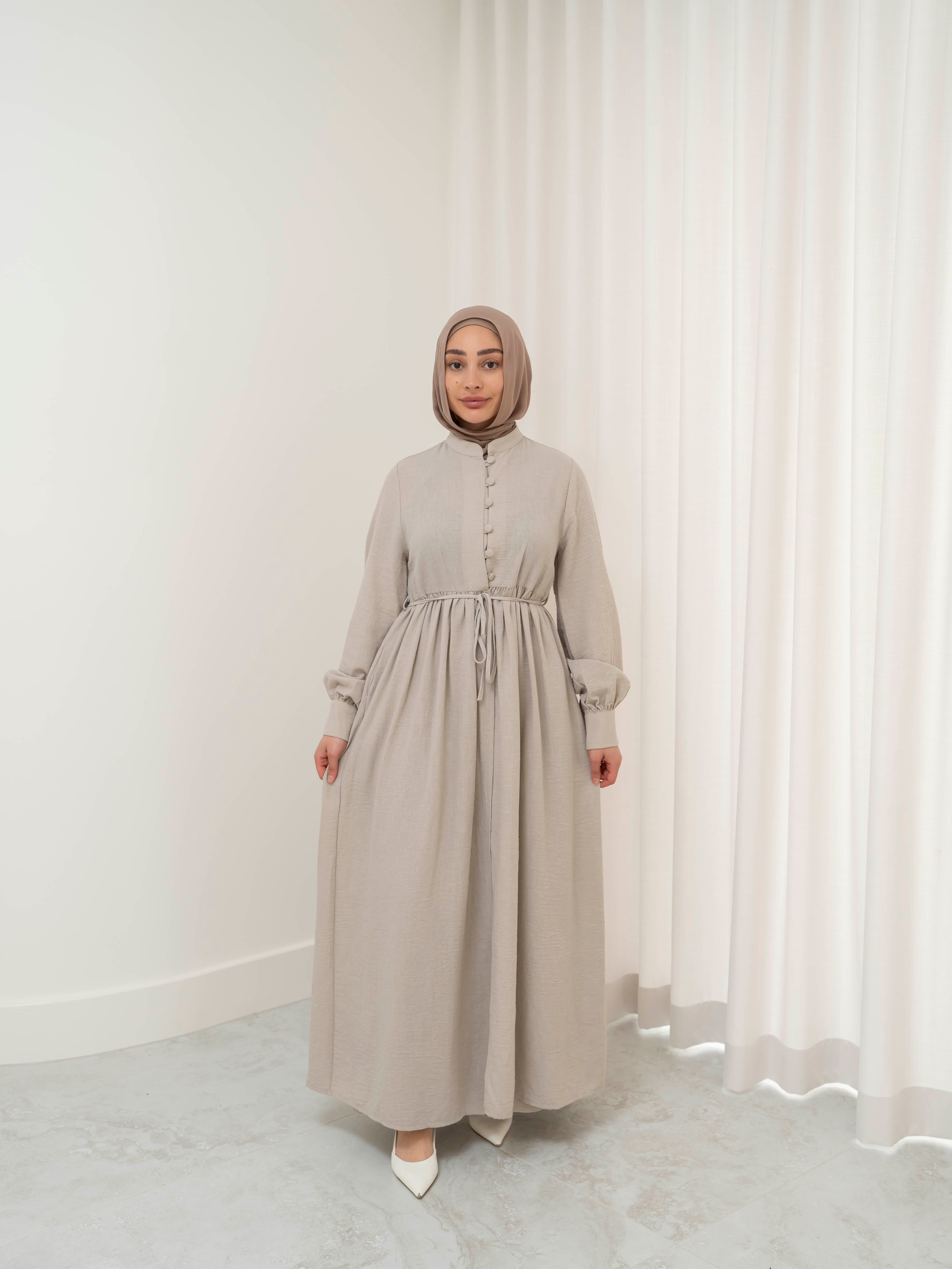 Luna Dress & Pant Set, a two-piece outfit featuring a flowing button-front dress with adjustable waist tie and matching high-waisted pants with elastic waistband and side pockets. Long sleeves with cuffs, lightweight fabric with elegant drape, designed for modest, polished looks suitable for Eid, special occasions, or everyday wear.