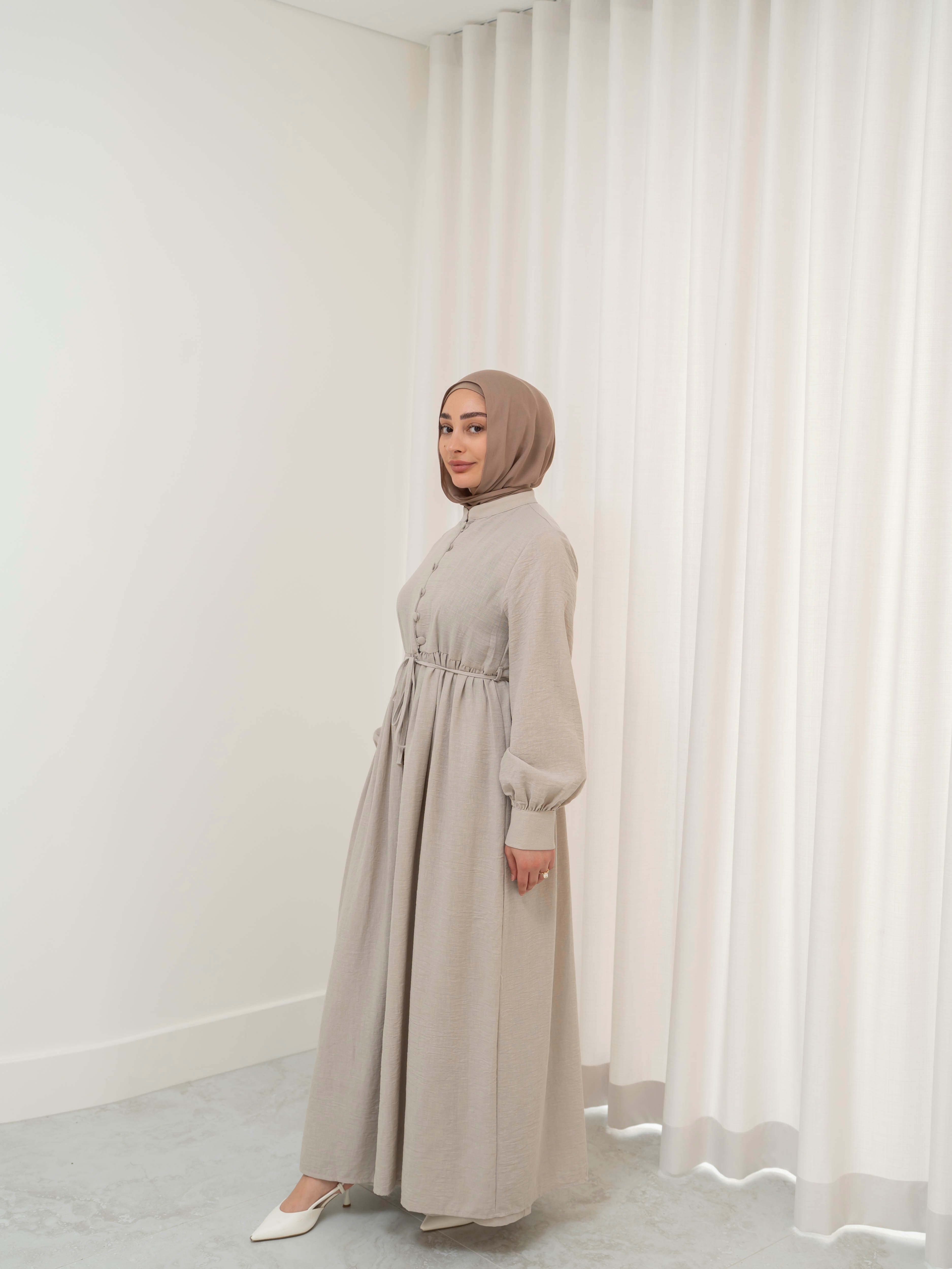 Luna Dress & Pant Set, a two-piece outfit featuring a flowing button-front dress with adjustable waist tie and matching high-waisted pants with elastic waistband and side pockets. Long sleeves with cuffs, lightweight fabric with elegant drape, designed for modest, polished looks suitable for Eid, special occasions, or everyday wear.