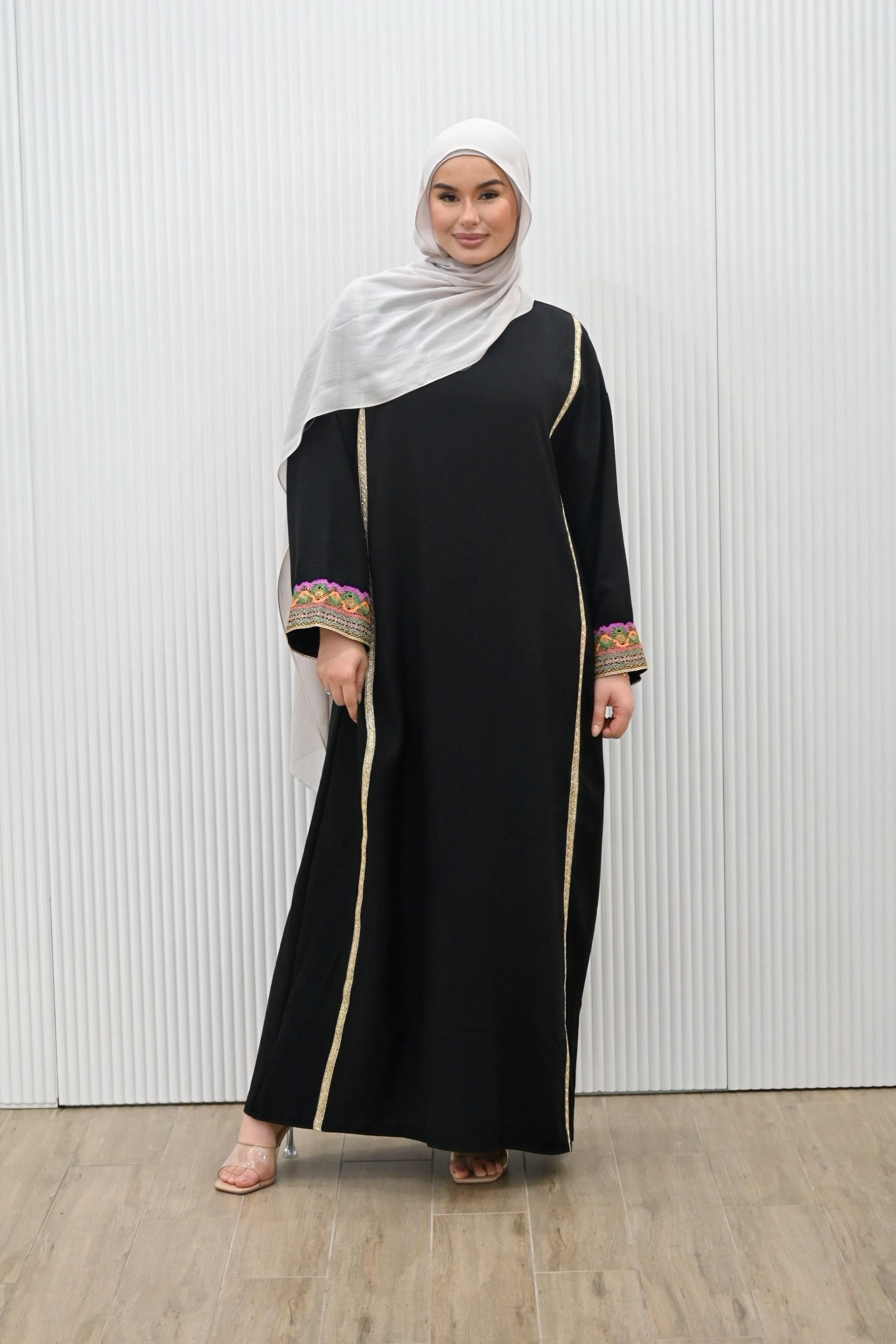 The MANEL DRESS - the perfect addition to your wardrobe. With its style silhouette adding a modest elegance, this dress is ideal for any evening occasions or a look for an invites. The long kimono sleeves feature intricate embroidery in a vibrant multi-coloured print, adding a touch of sparkle to your mood.