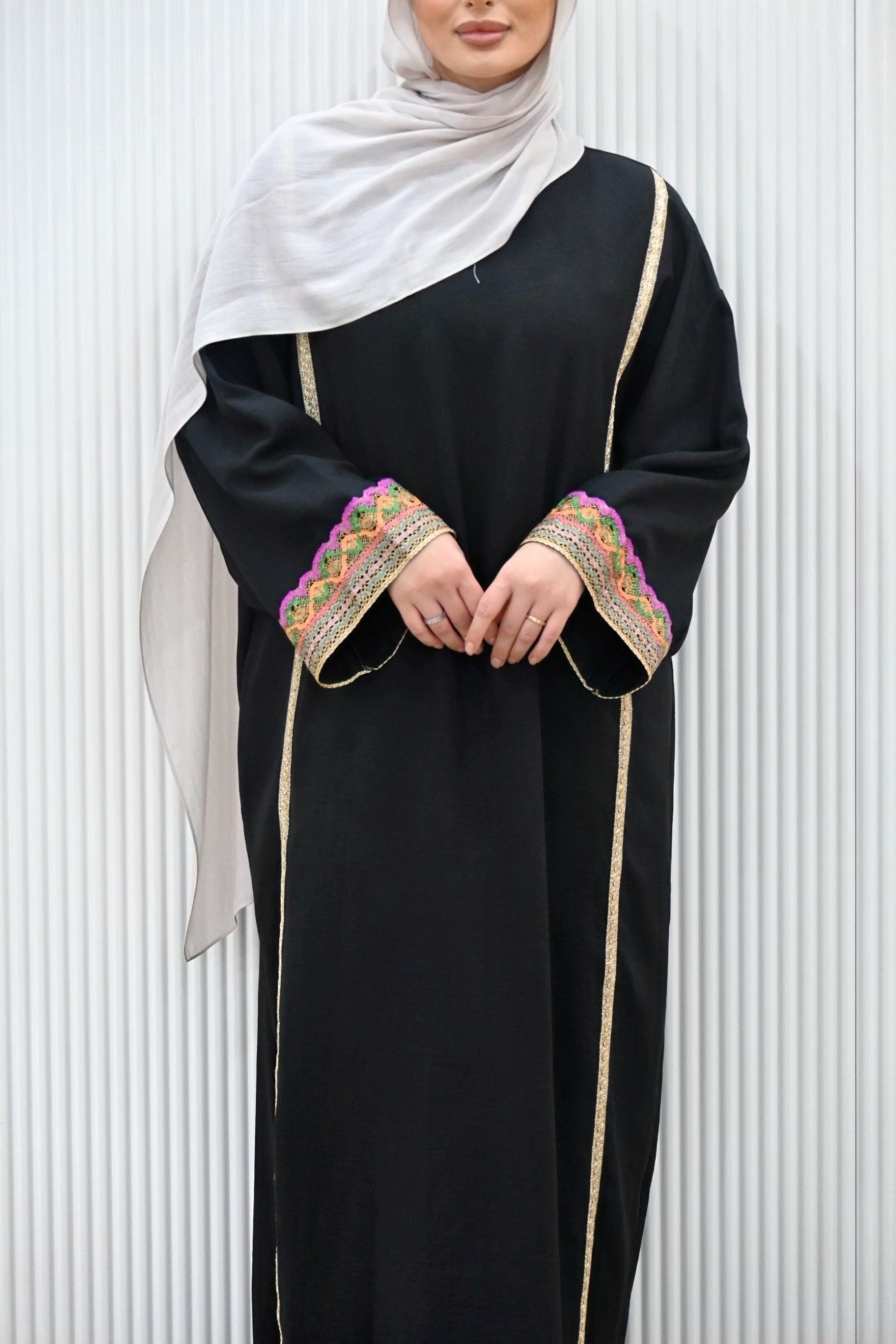 The MANEL DRESS - the perfect addition to your wardrobe. With its style silhouette adding a modest elegance, this dress is ideal for any evening occasions or a look for an invites. The long kimono sleeves feature intricate embroidery in a vibrant multi-coloured print, adding a touch of sparkle to your mood.