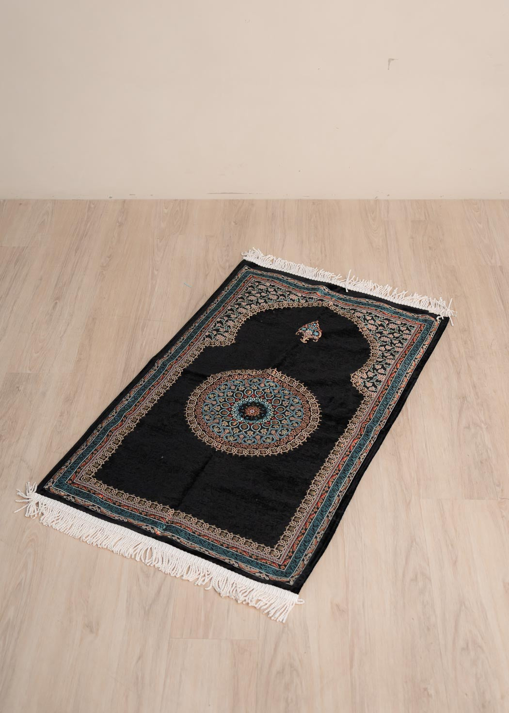 Soft cushioned prayer mat with braided fringe and traditional floral pattern 70cm x 120cm.