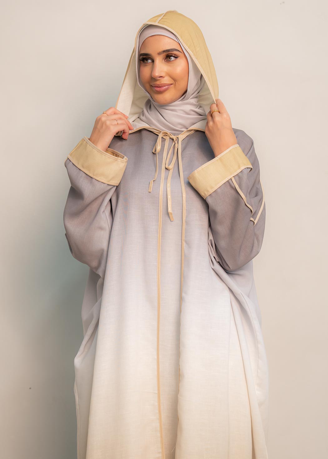 The hooded kaftan dress and tonal dress underlay provide versatility and comfort, while the lace tie neckline adds a feminine touch. Perfect for social occasions and functions, this set will be on high rotation in your wardrobe.