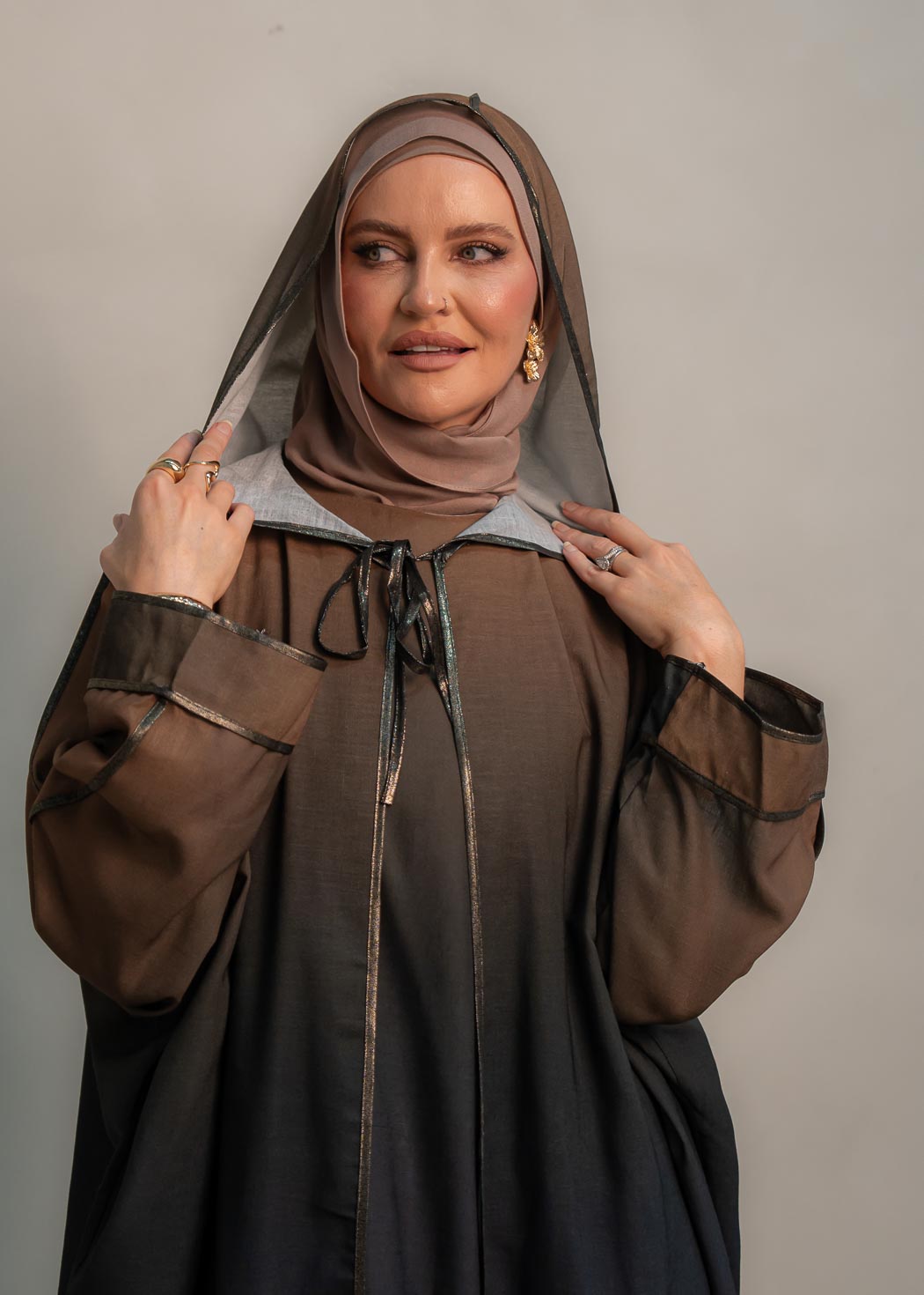 The hooded kaftan dress and tonal dress underlay provide versatility and comfort, while the lace tie neckline adds a feminine touch. Perfect for social occasions and functions, this set will be on high rotation in your wardrobe.