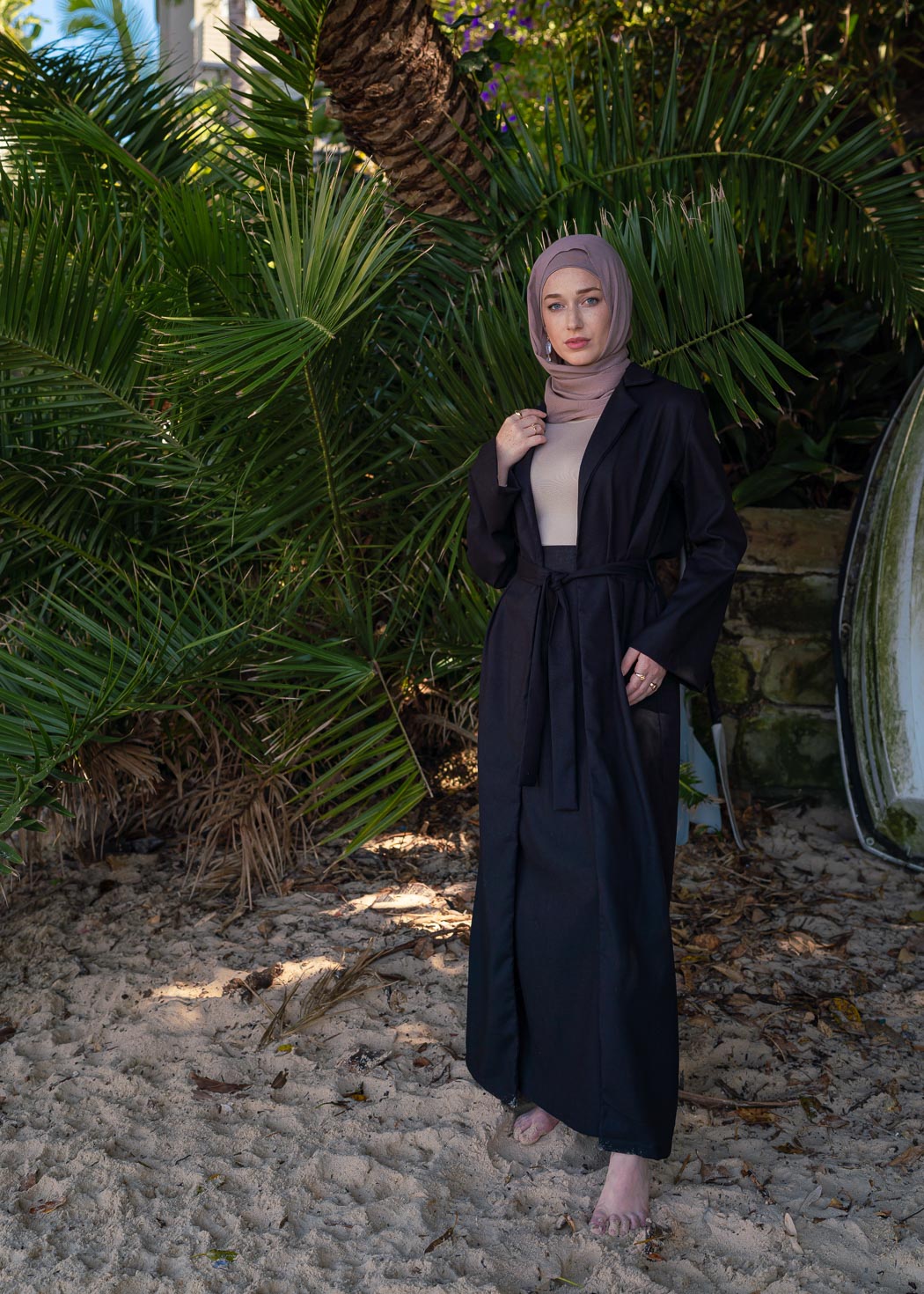 Black two-piece set featuring a maxi-length duster coat and elastic-waist wide-leg skirt, designed in a relaxed, throw-on style for comfortable, effortless wear across seasons.