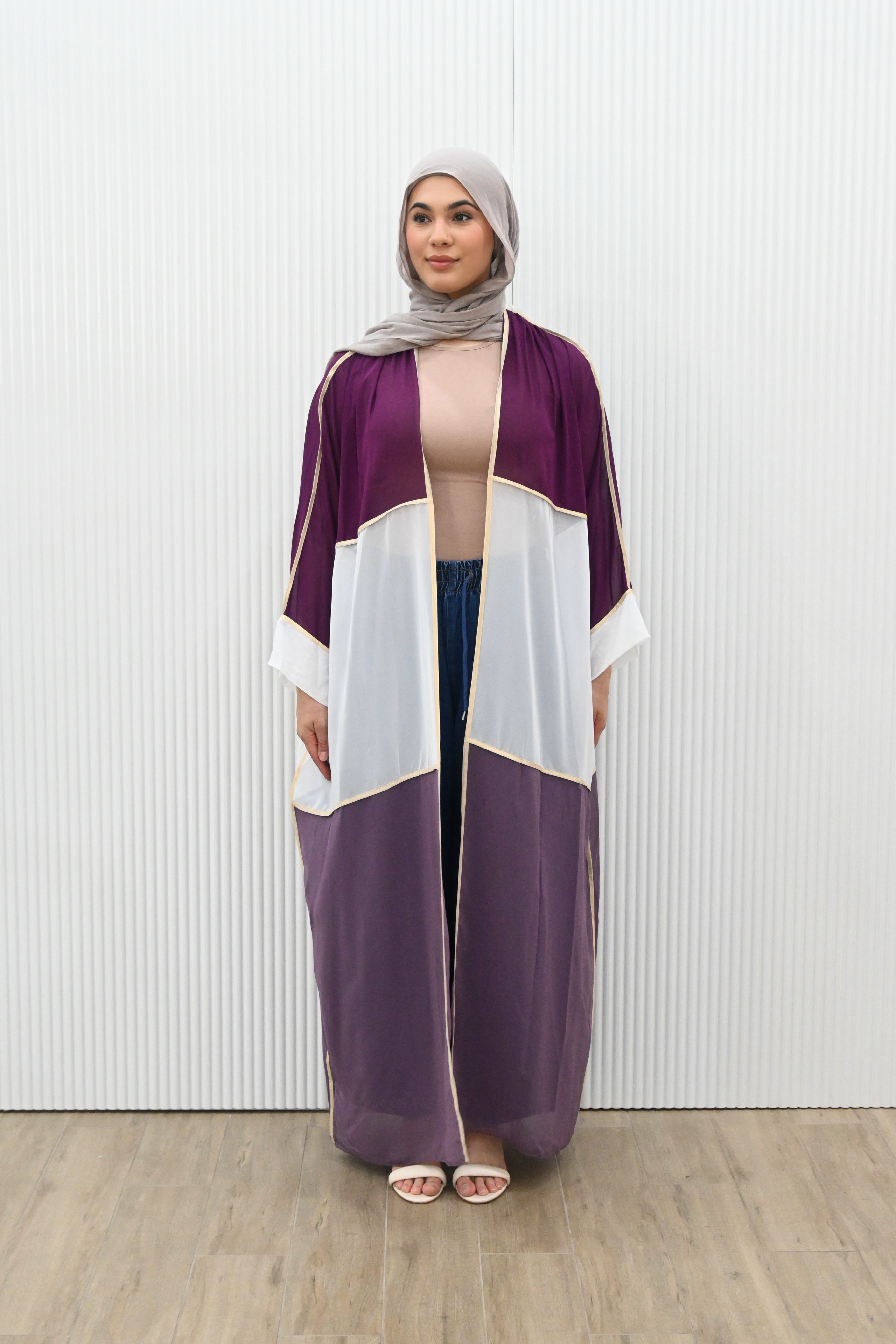 Introducing the OPULENT CONTRAST DUSTER - the perfect piece to make a statement. With its luxe overlay and gold trimming, this duster exudes sophistication. The contrast colour panelling adds visual interest while the long kimono sleeves, sheer hem, and loose drape provide a beautiful layering option. Elevate your wardrobe with this must-have piece.