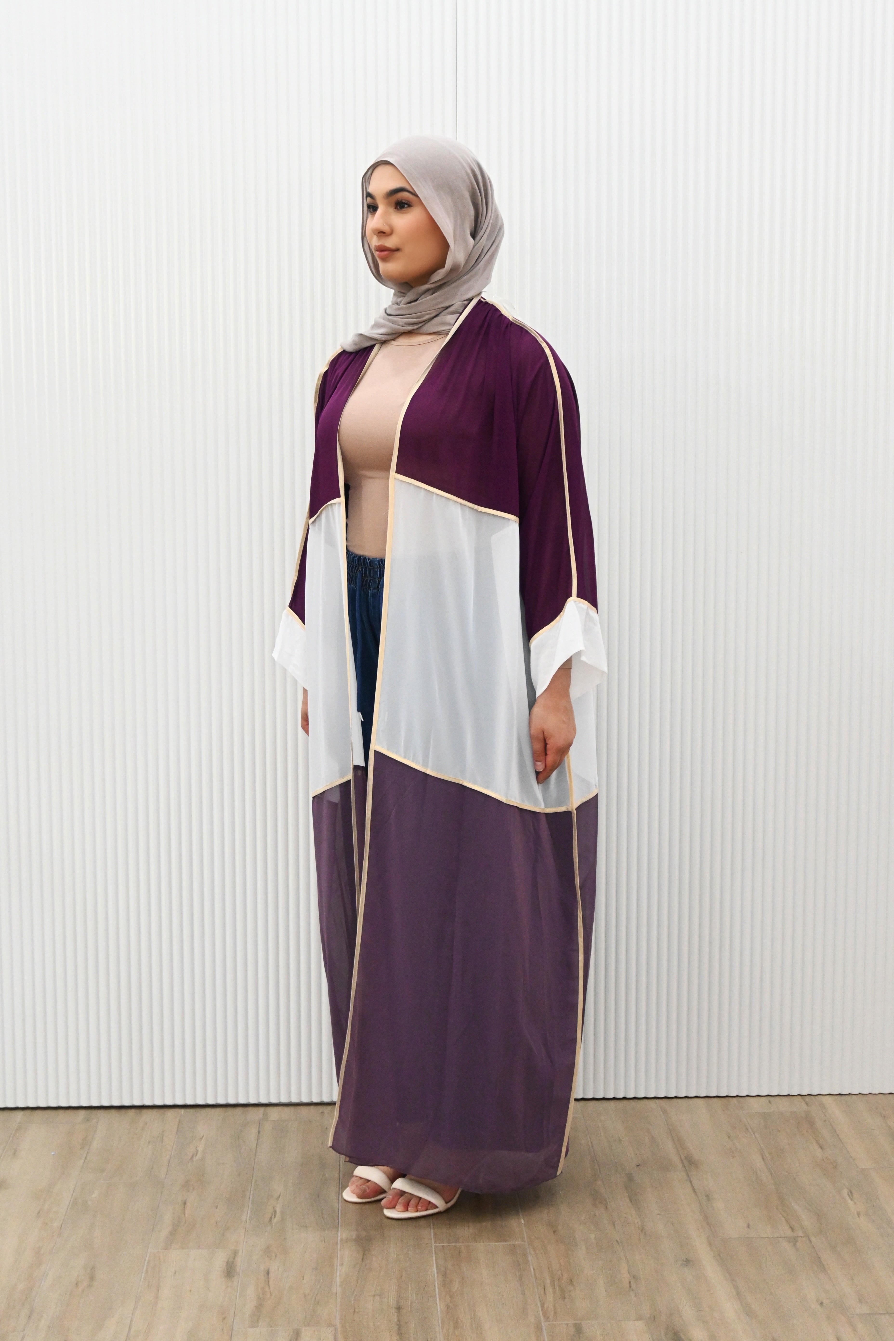 Introducing the OPULENT CONTRAST DUSTER - the perfect piece to make a statement. With its luxe overlay and gold trimming, this duster exudes sophistication. The contrast colour panelling adds visual interest while the long kimono sleeves, sheer hem, and loose drape provide a beautiful layering option. Elevate your wardrobe with this must-have piece.