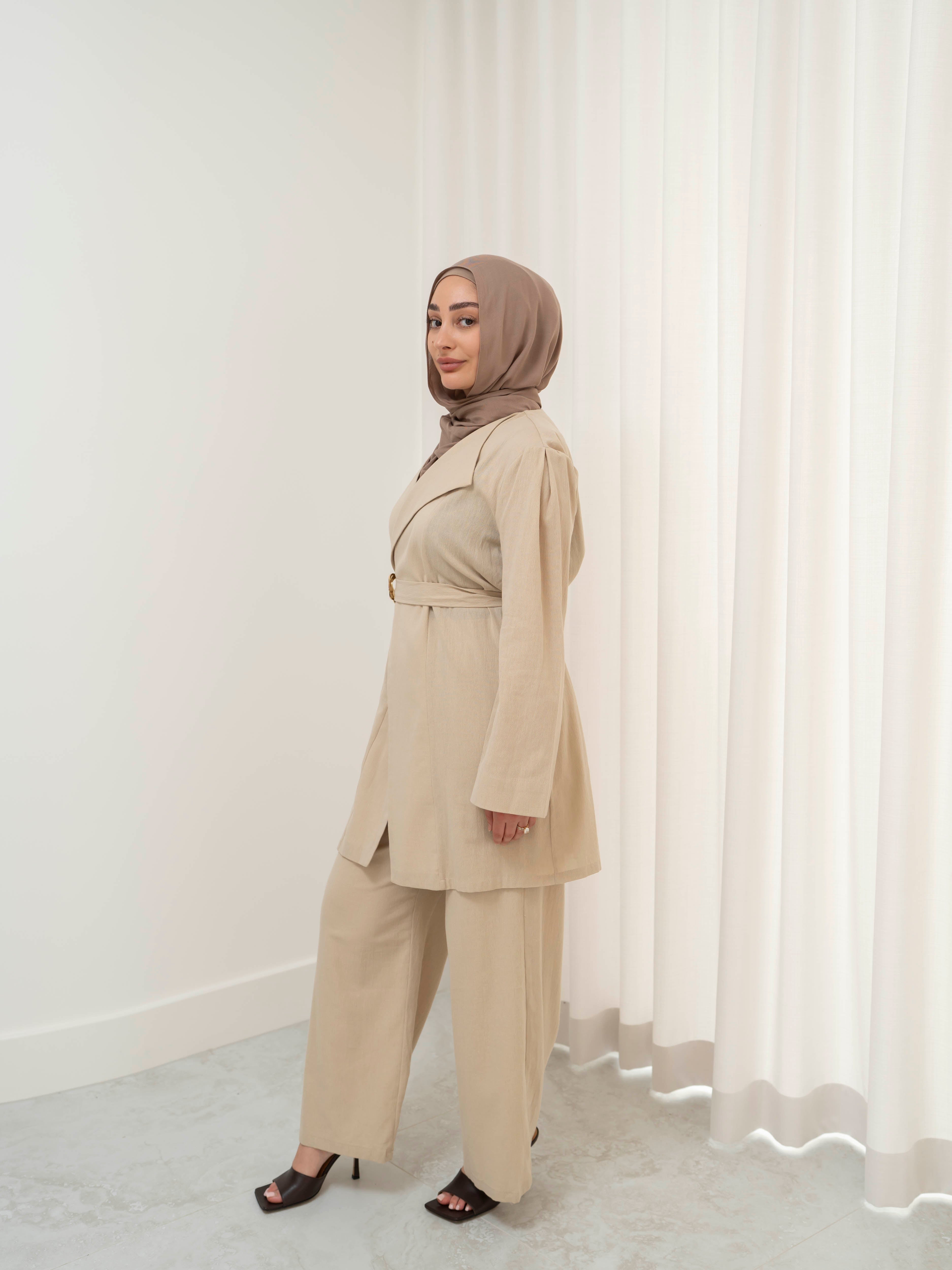 Raya Tailored Set, a two-piece outfit with a belted tailored jacket featuring structured lapels and matching wide-leg pants with elasticated waistband. Full-length, modest silhouette in lightweight fabric with refined drape, ideal for Eid, formal occasions, or elevated everyday wear.