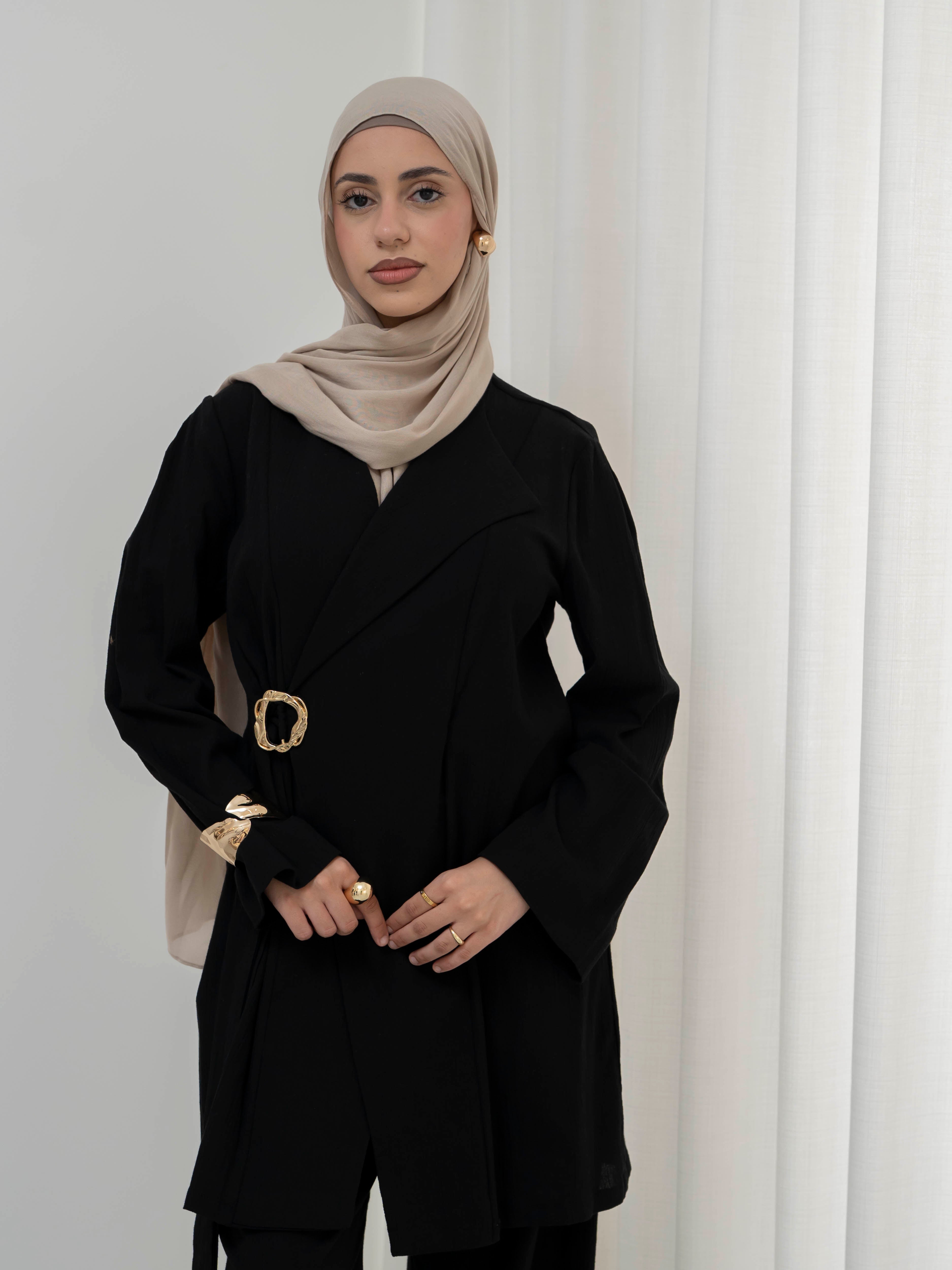 Raya Tailored Set, a two-piece outfit with a belted tailored jacket featuring structured lapels and matching wide-leg pants with elasticated waistband. Full-length, modest silhouette in lightweight fabric with refined drape, ideal for Eid, formal occasions, or elevated everyday wear.