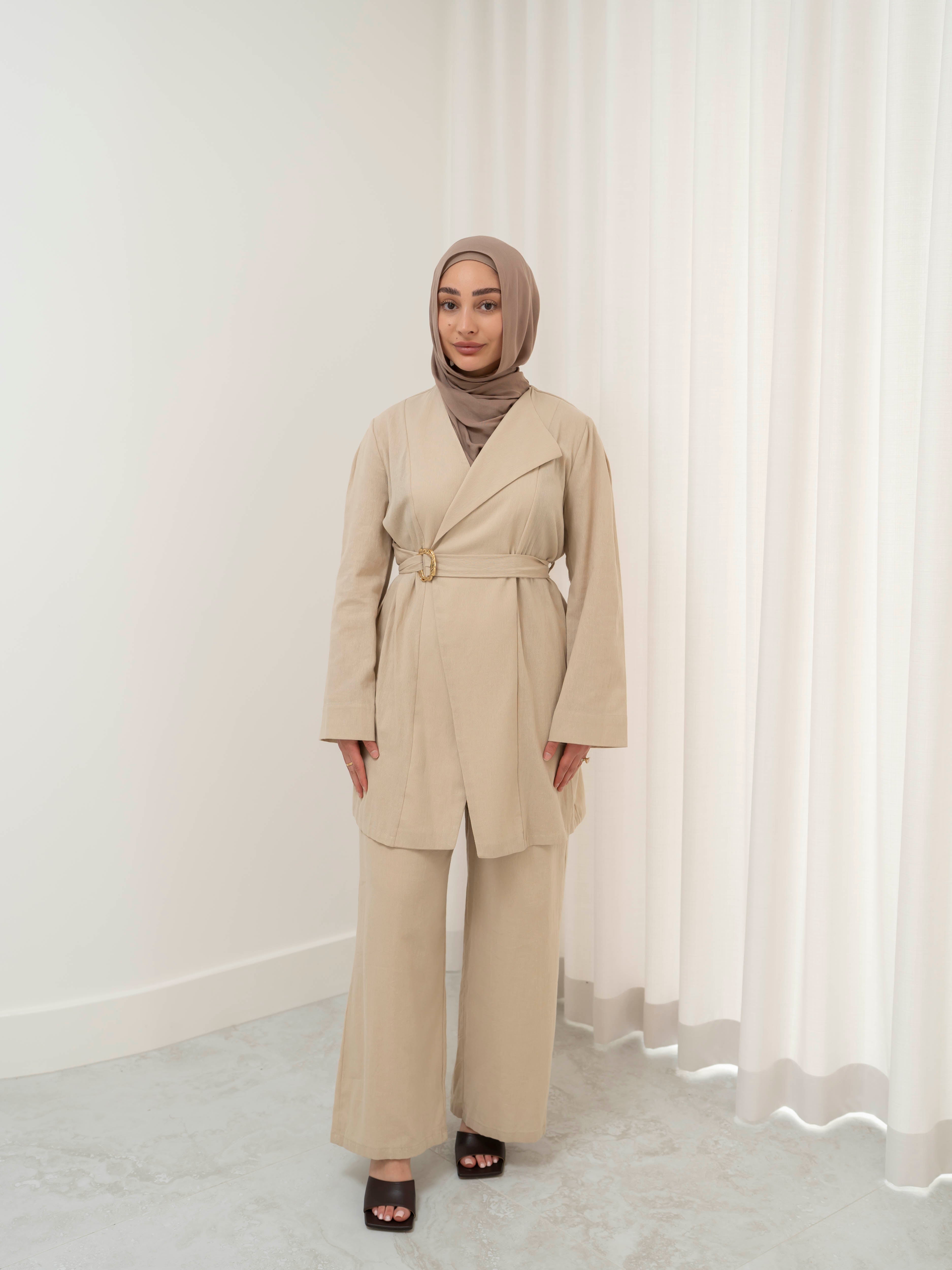 Raya Tailored Set, a two-piece outfit with a belted tailored jacket featuring structured lapels and matching wide-leg pants with elasticated waistband. Full-length, modest silhouette in lightweight fabric with refined drape, ideal for Eid, formal occasions, or elevated everyday wear.