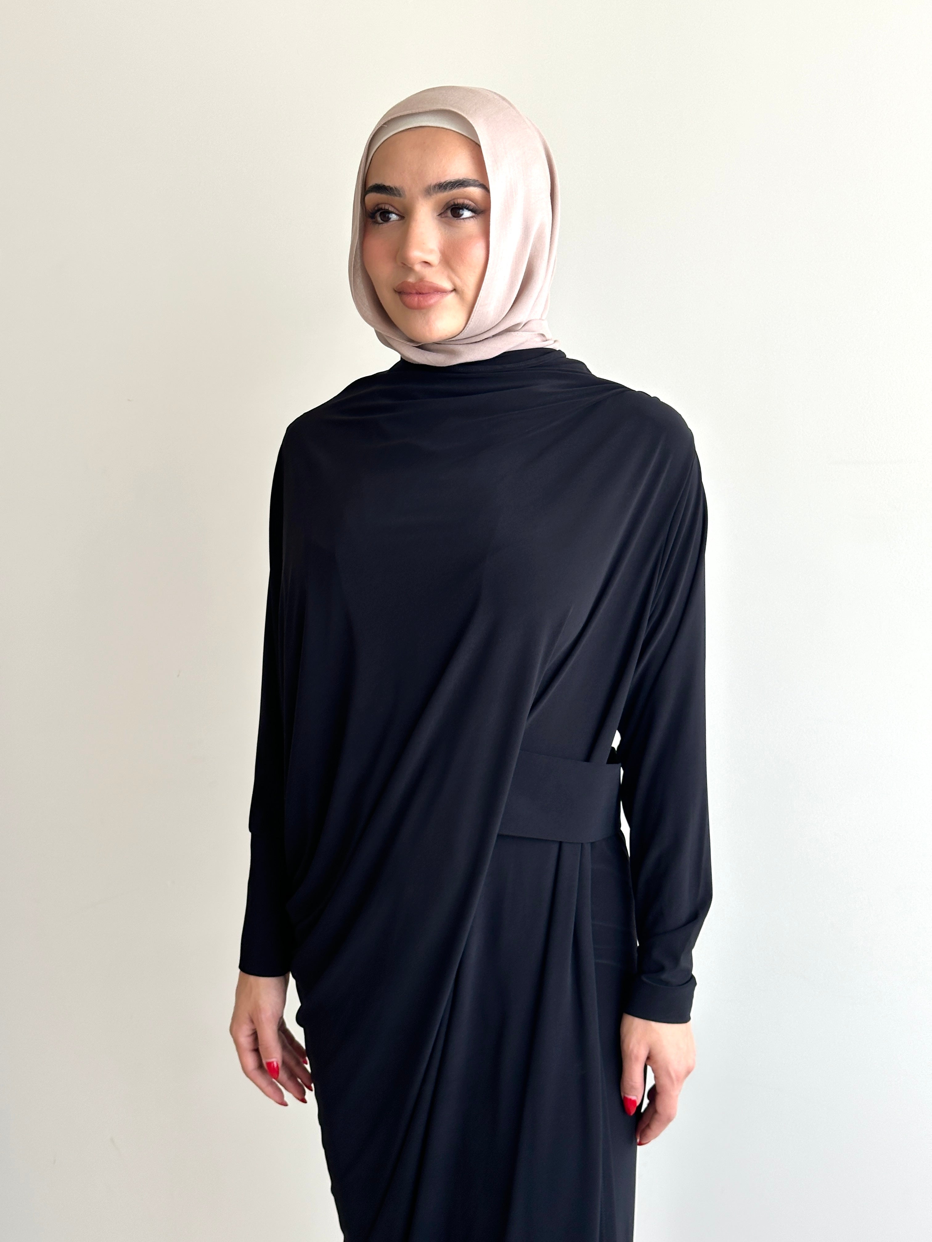 Crafted from a soft, breathable jersey fabric, this dress drapes beautifully over the silhouette while offering stretch and movement that feels as comfortable as it looks.